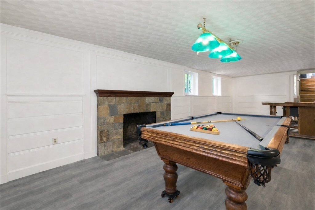 29 Boulevard Road Dedham, MA 02026 - Photo 25 of 34 a living room with a table and a fireplace