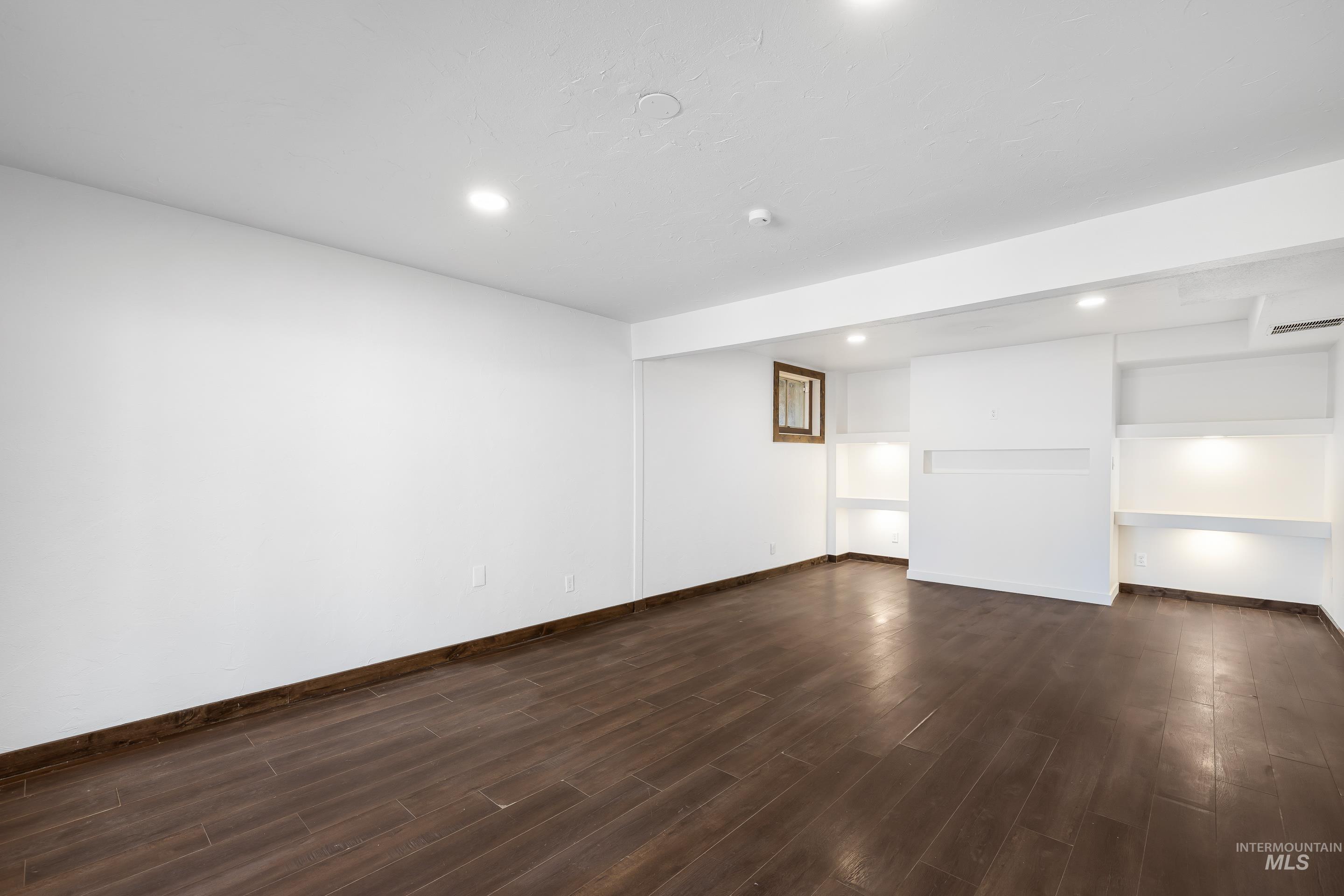 10294 West Fox Ridge Drive Boise, ID 83709 - Photo 24 of 50 Finished below grade area featuring recessed lighting and dark wood-style flooring