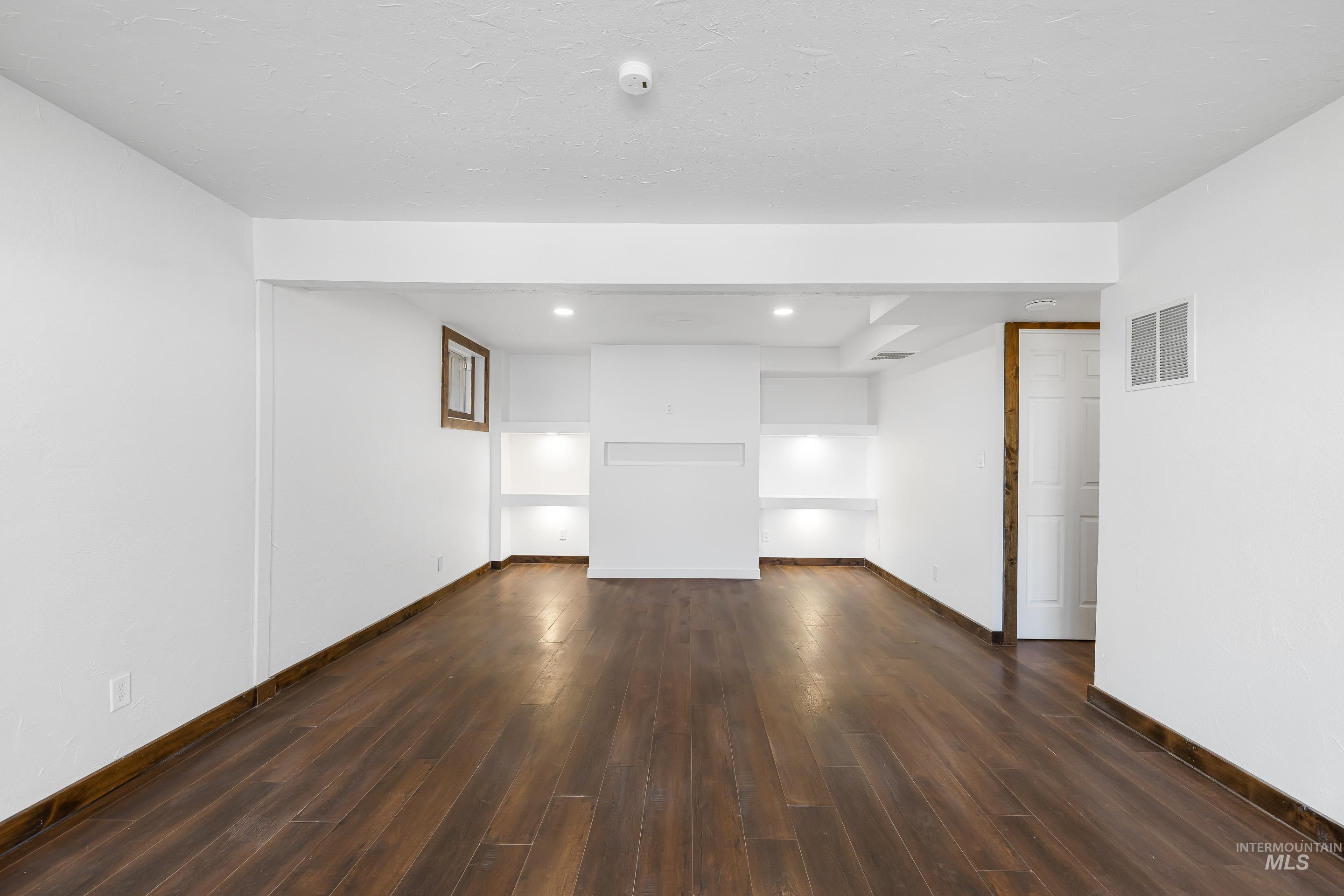10294 West Fox Ridge Drive Boise, ID 83709 - Photo 25 of 50 Empty room featuring dark wood-style flooring and recessed lighting