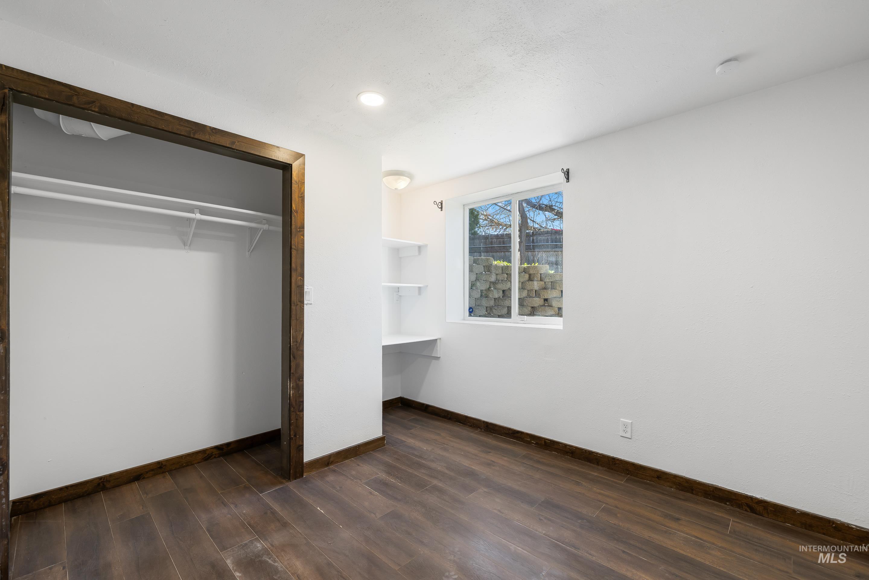 10294 West Fox Ridge Drive Boise, ID 83709 - Photo 30 of 50 Unfurnished bedroom with dark wood-style flooring, a closet, and recessed lighting