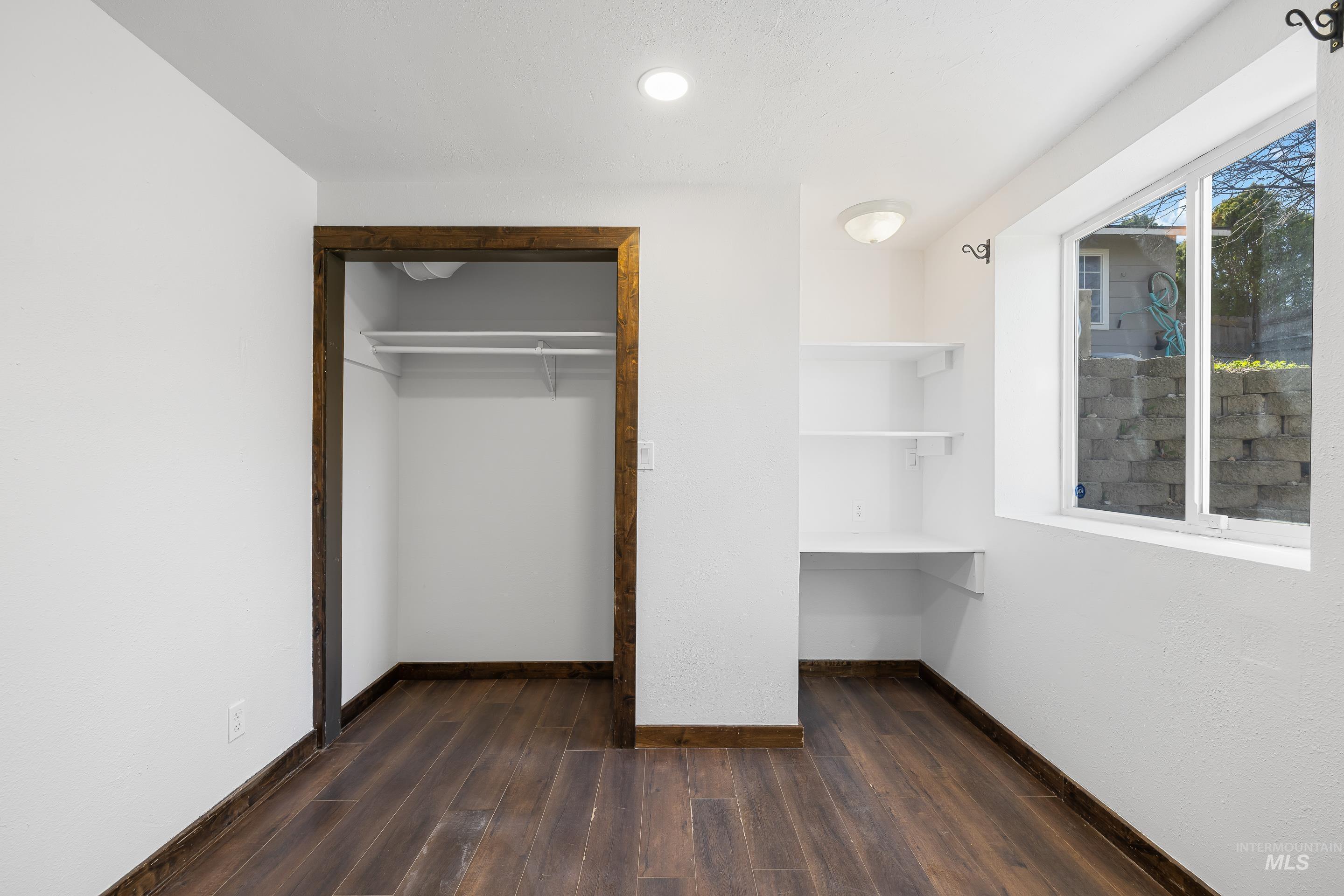 10294 West Fox Ridge Drive Boise, ID 83709 - Photo 31 of 50 Unfurnished bedroom with dark wood finished floors and a closet