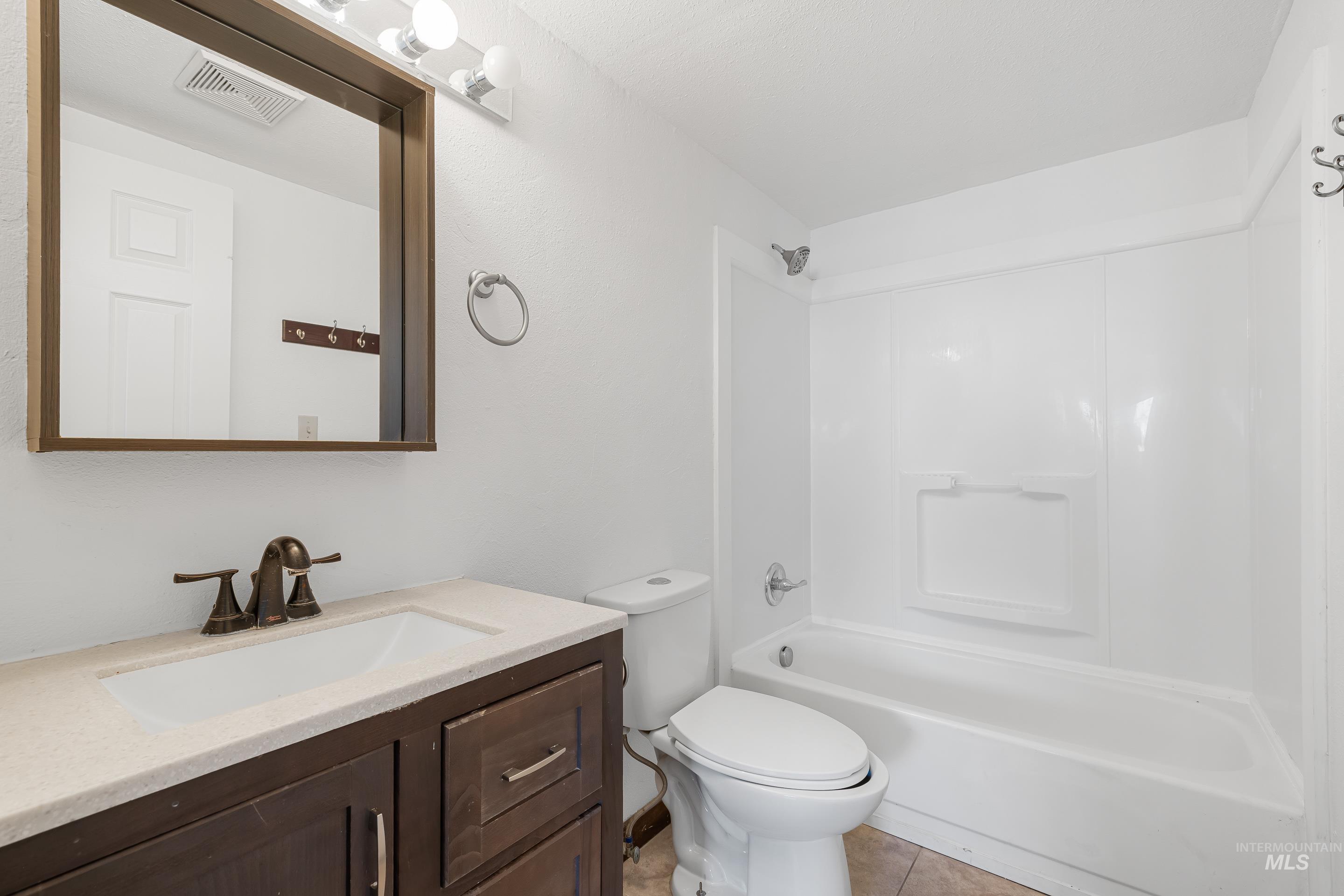 10294 West Fox Ridge Drive Boise, ID 83709 - Photo 32 of 50 Full bath with vanity, shower combination, and light tile patterned floors