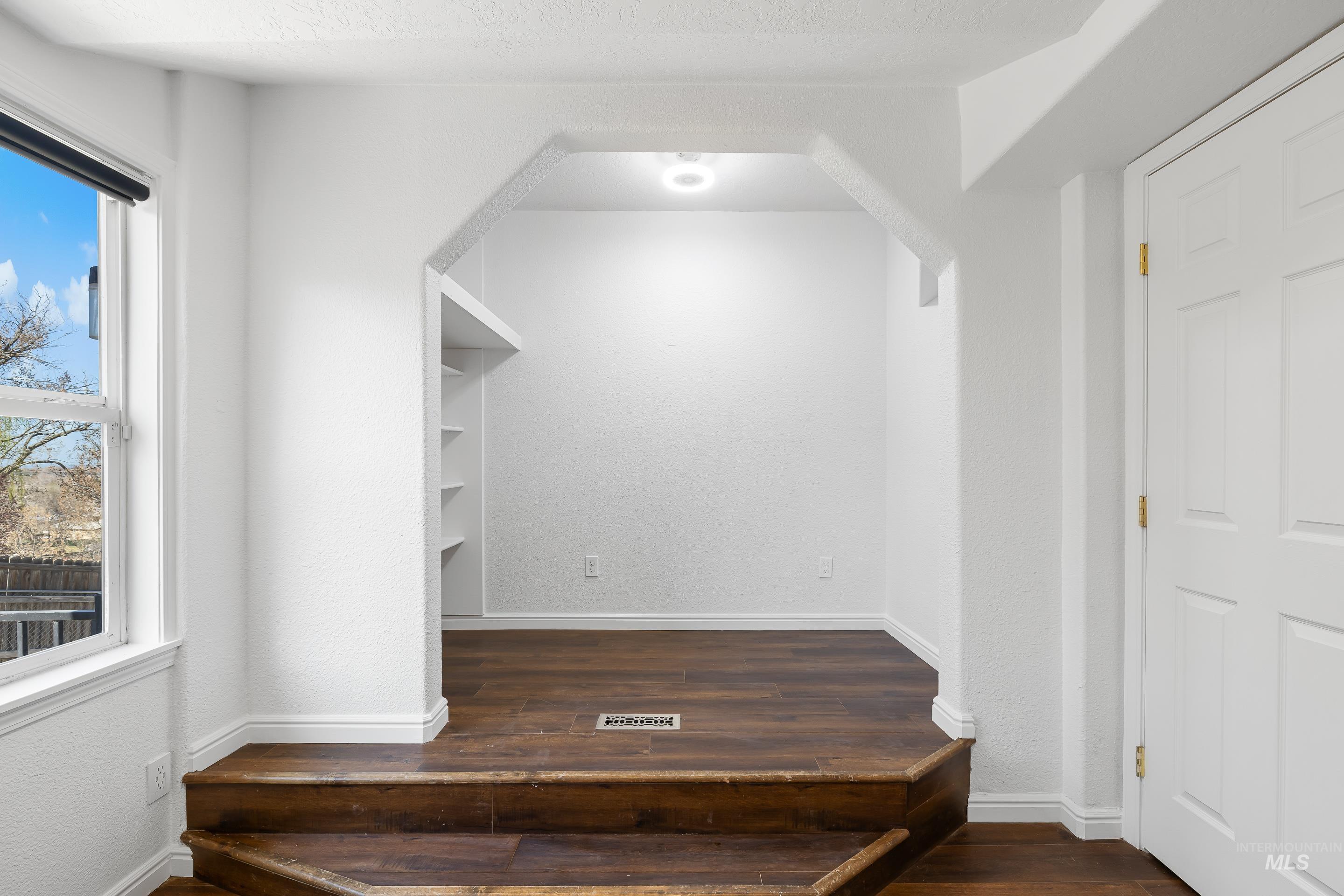 10294 West Fox Ridge Drive Boise, ID 83709 - Photo 34 of 50 Interior space with dark wood-type flooring and baseboards