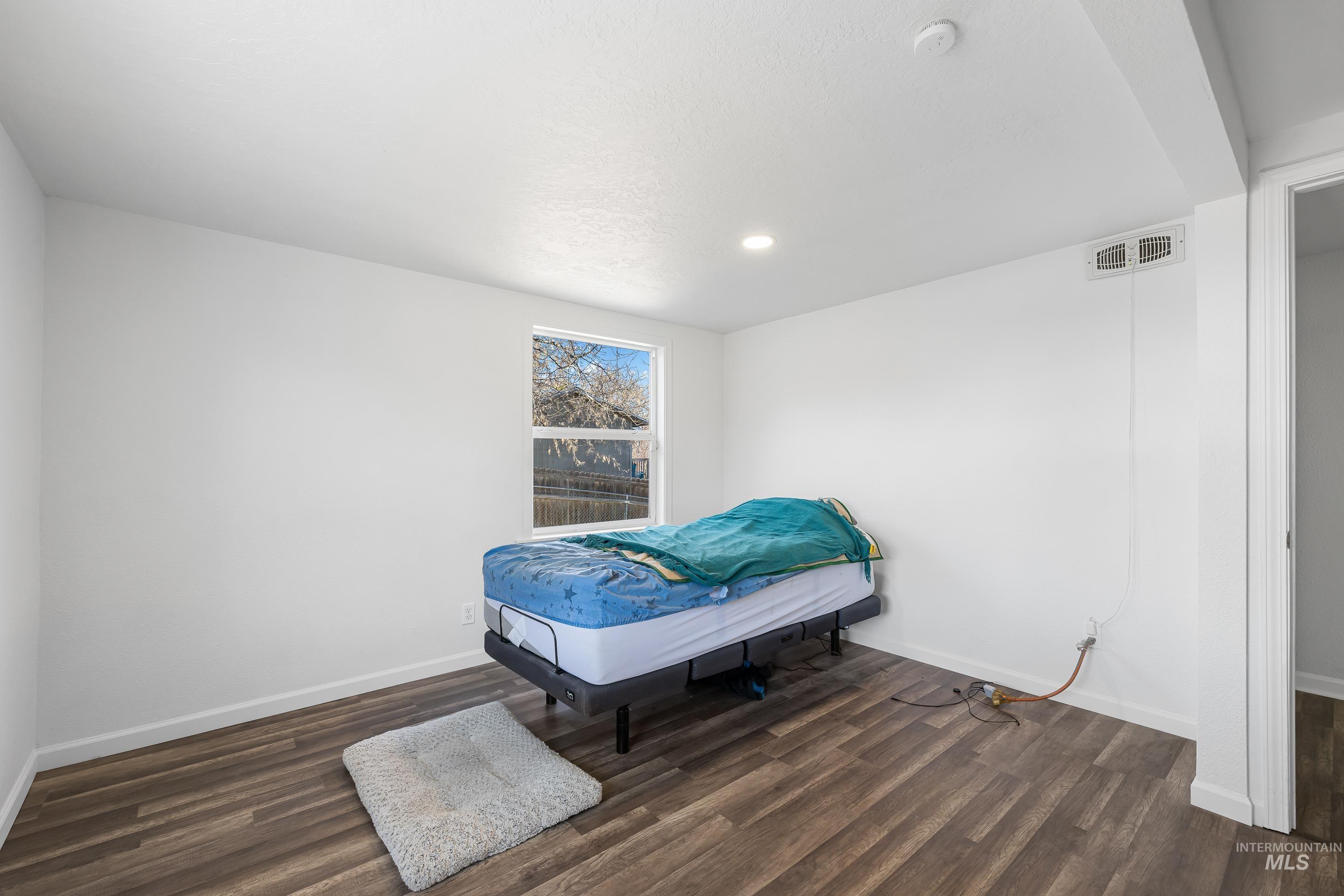 10294 West Fox Ridge Drive Boise, ID 83709 - Photo 36 of 50 Bedroom featuring dark wood-style floors