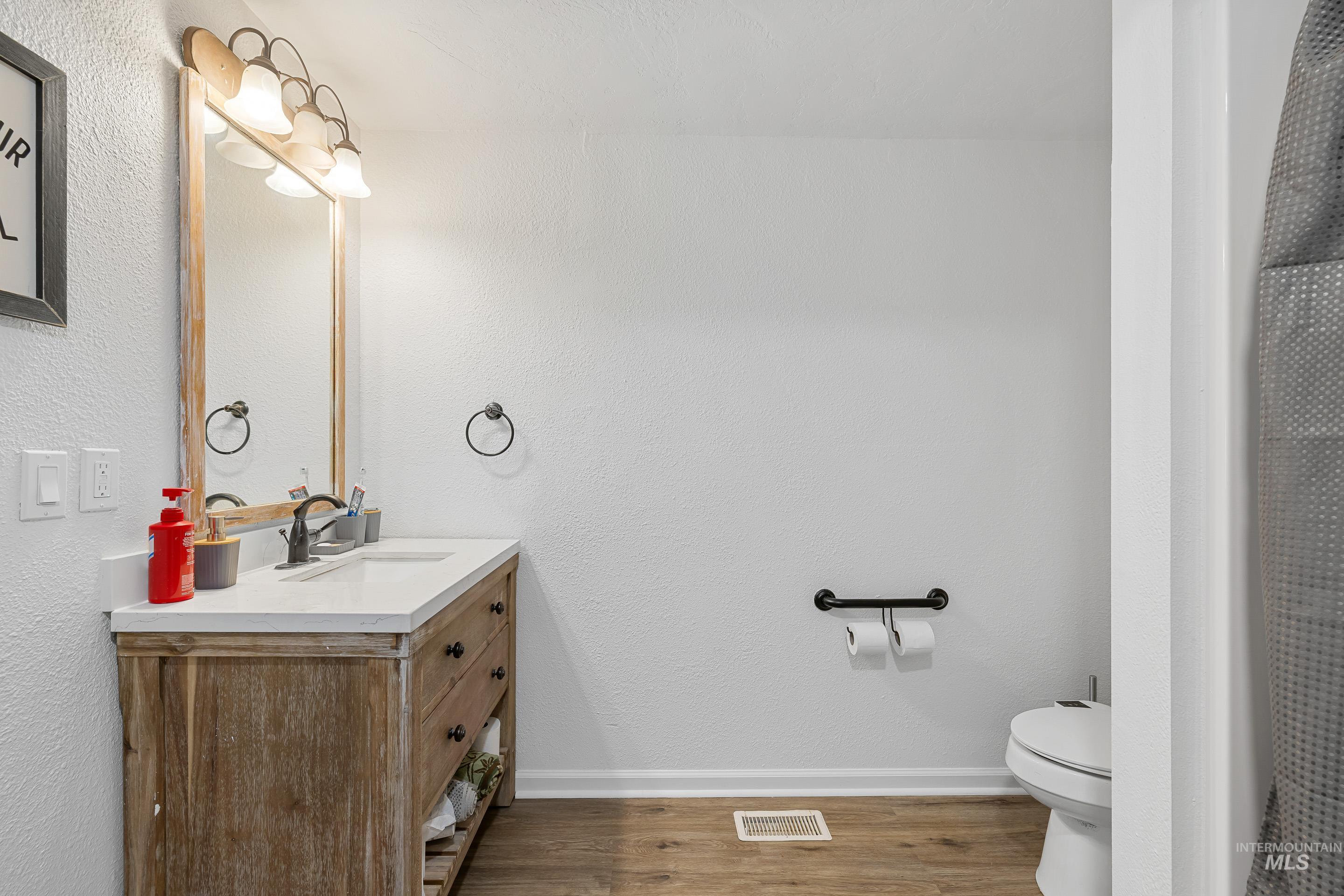 10294 West Fox Ridge Drive Boise, ID 83709 - Photo 37 of 50 Bathroom with vanity, light wood-type flooring, and a shower with curtain