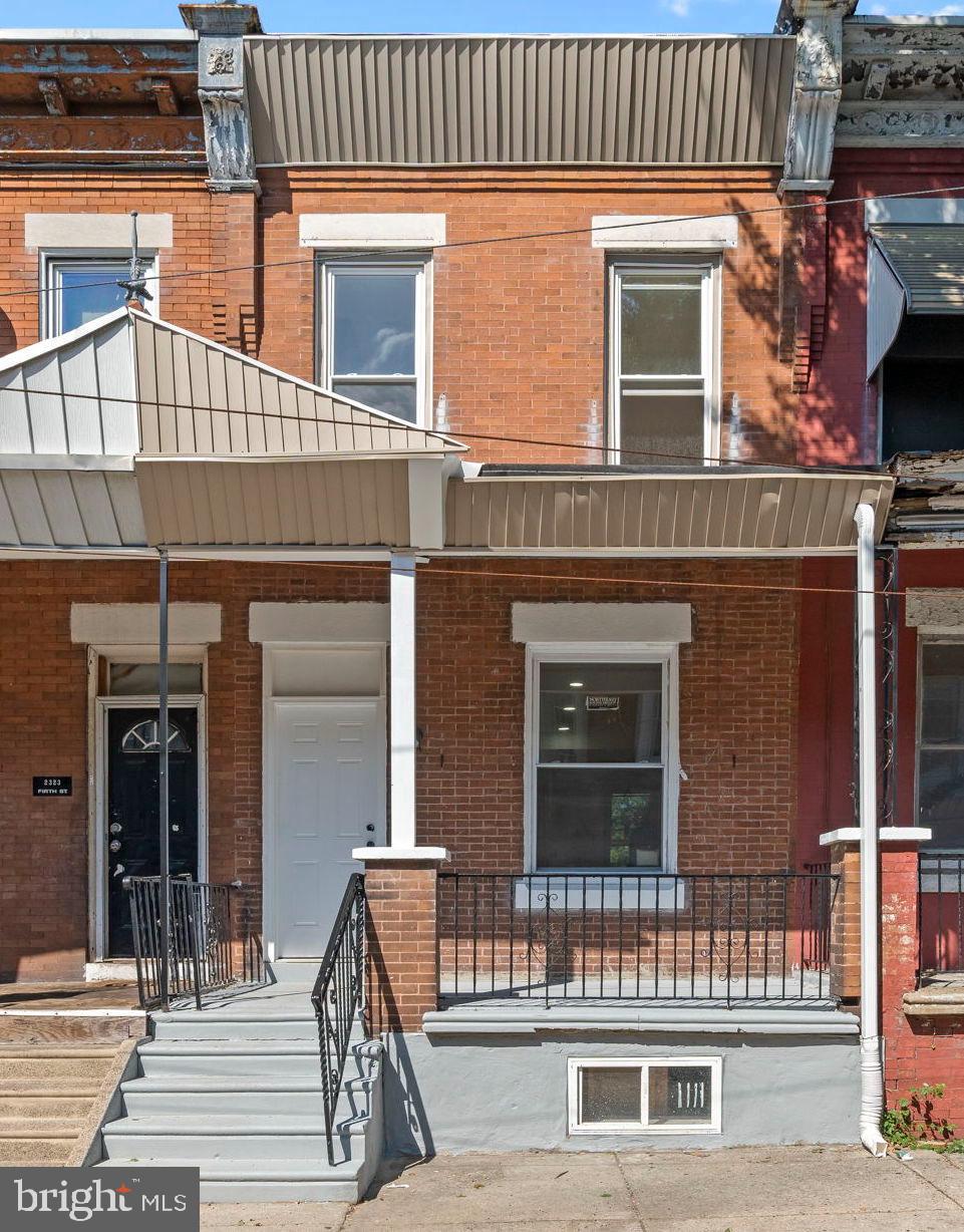 Charming brick facade with inviting porch.