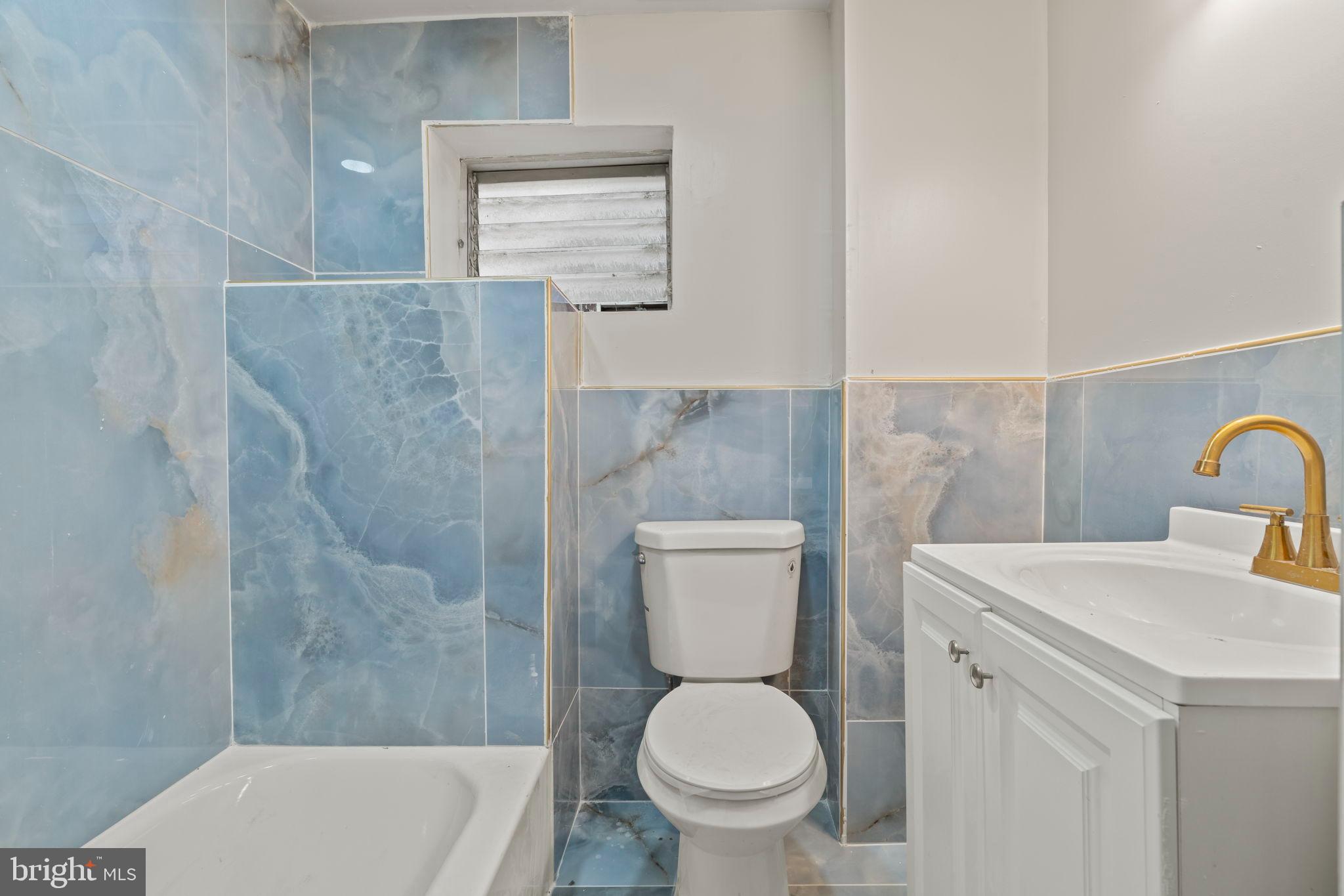 2321 West Firth Street Philadelphia, PA 19132 - Photo 7 of 21 Serene bathroom with elegant blue tiles.