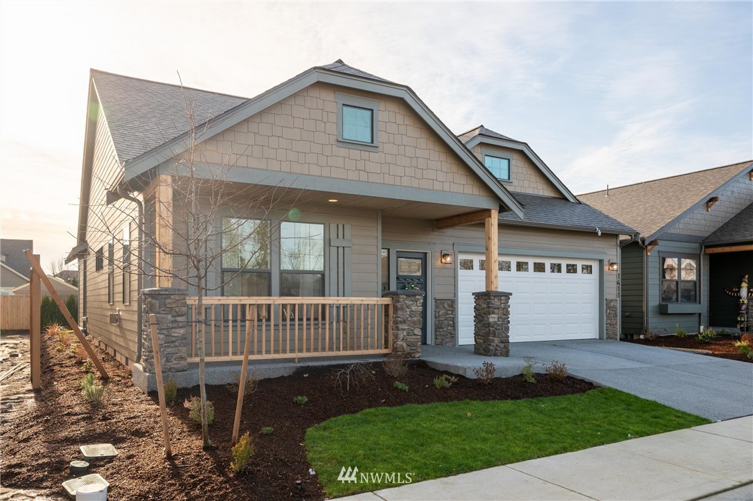 1411 Woods Point Loop Ferndale, WA 98248 - Photo 2 of 31 a front view of a house with a garden