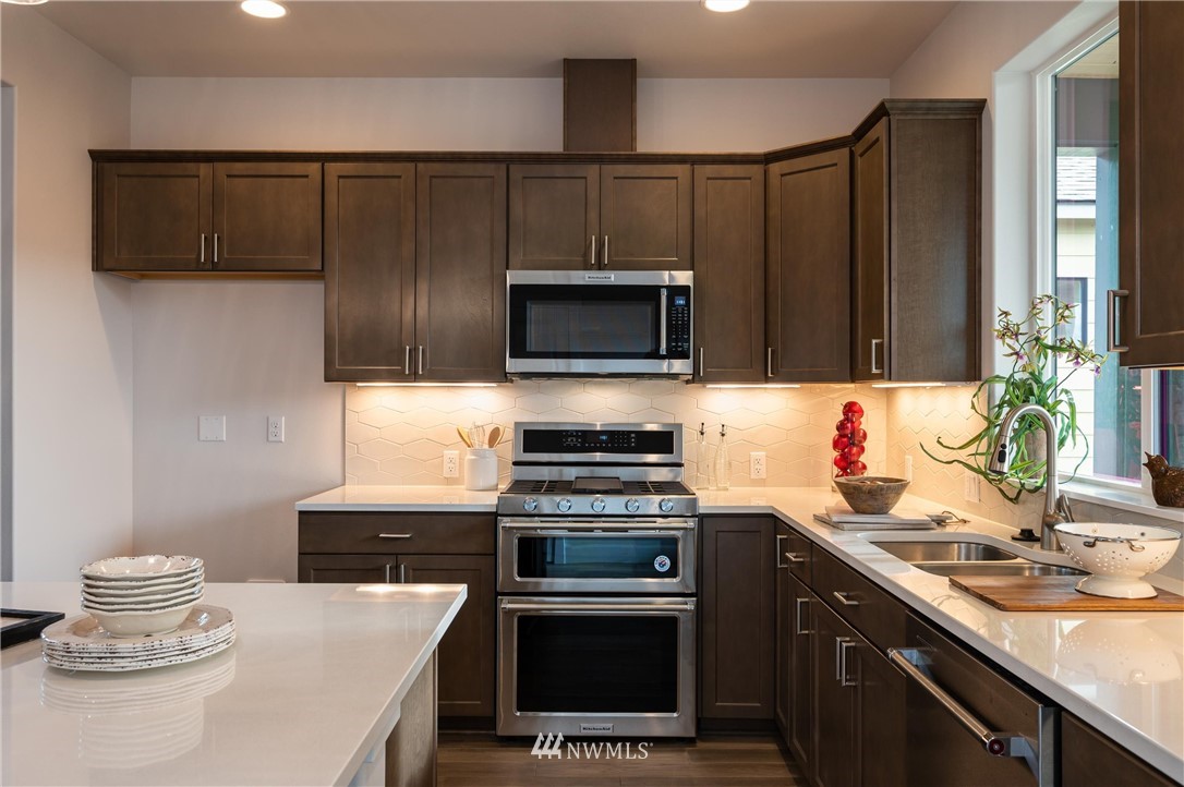 1411 Woods Point Loop Ferndale, WA 98248 - Photo 11 of 31 a kitchen with a sink stove and microwave