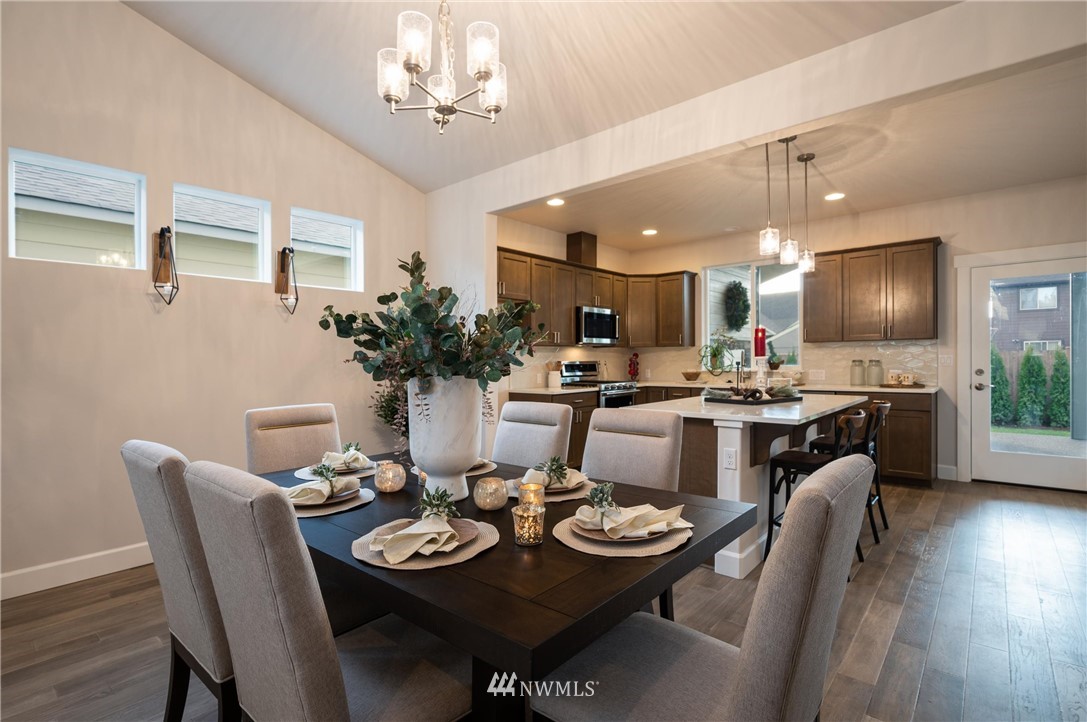 1411 Woods Point Loop Ferndale, WA 98248 - Photo 12 of 31 a view of a dining room with furniture and wooden floor
