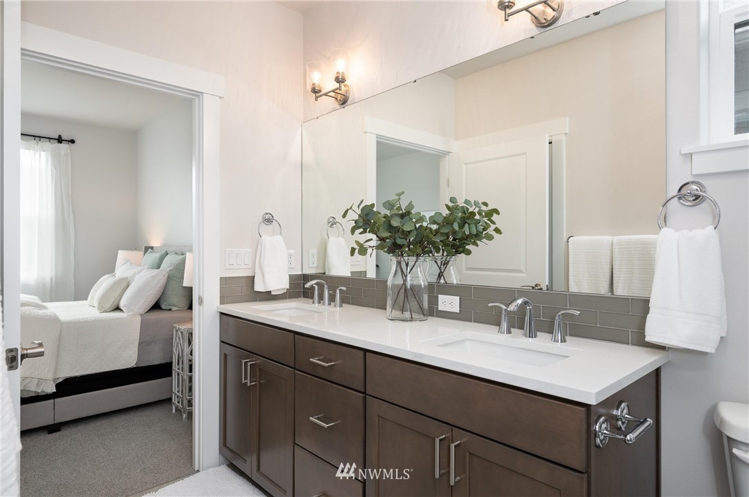 1411 Woods Point Loop Ferndale, WA 98248 - Photo 17 of 31 a bathroom with a sink double vanity and a mirror