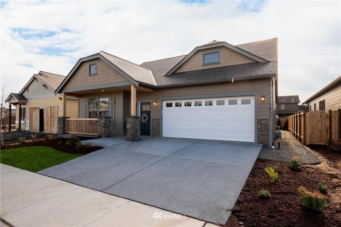 1411 Woods Point Loop Ferndale, WA 98248 - Photo 3 of 31 a front view of a house with a yard and garage