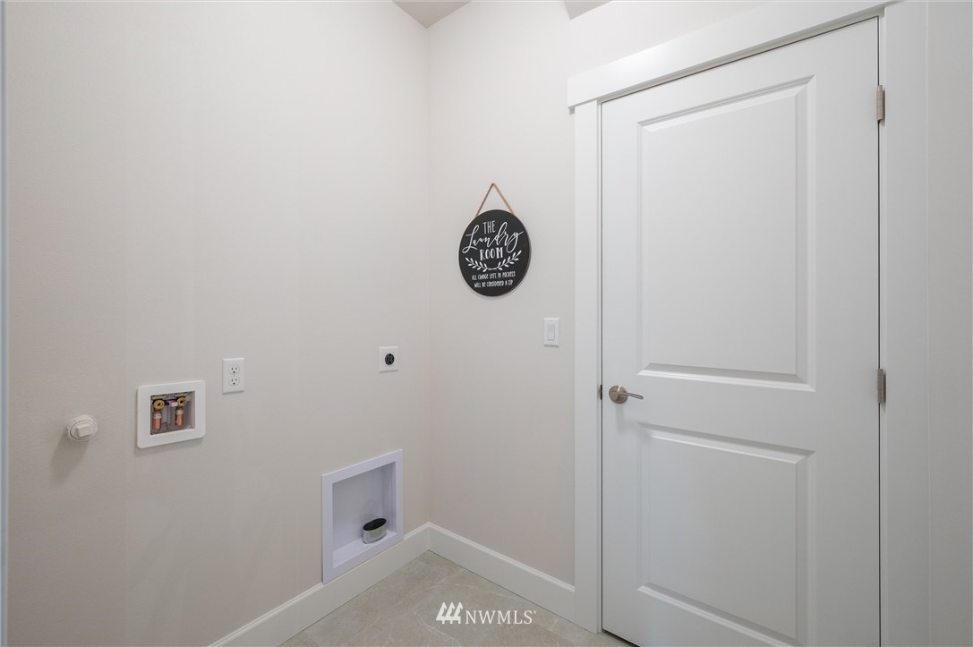 1411 Woods Point Loop Ferndale, WA 98248 - Photo 22 of 31 a view of room with baby crib and wooden floor