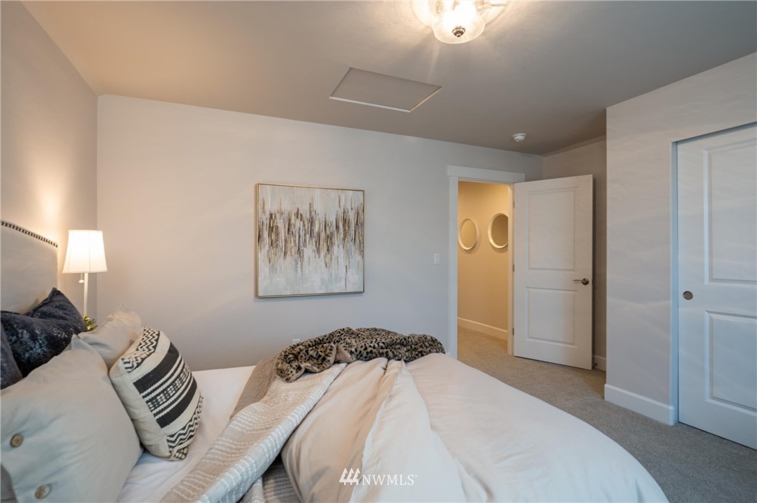 1411 Woods Point Loop Ferndale, WA 98248 - Photo 25 of 31 a bedroom with a bed and a painting on the wall