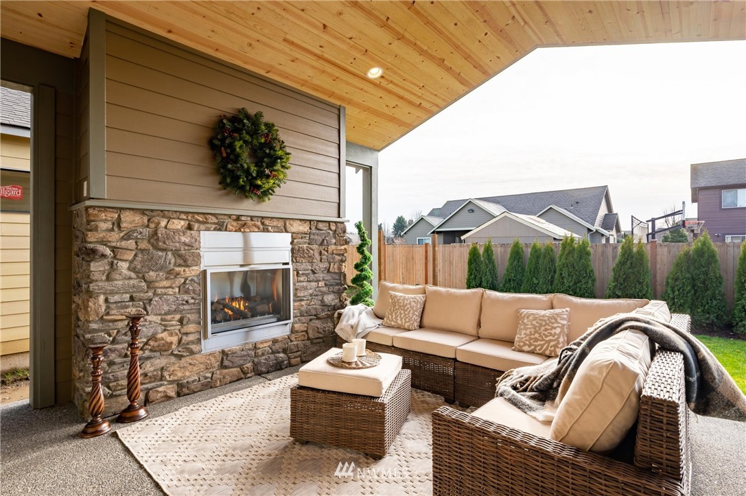 1411 Woods Point Loop Ferndale, WA 98248 - Photo 27 of 31 a outdoor living space with patio furniture and a fireplace