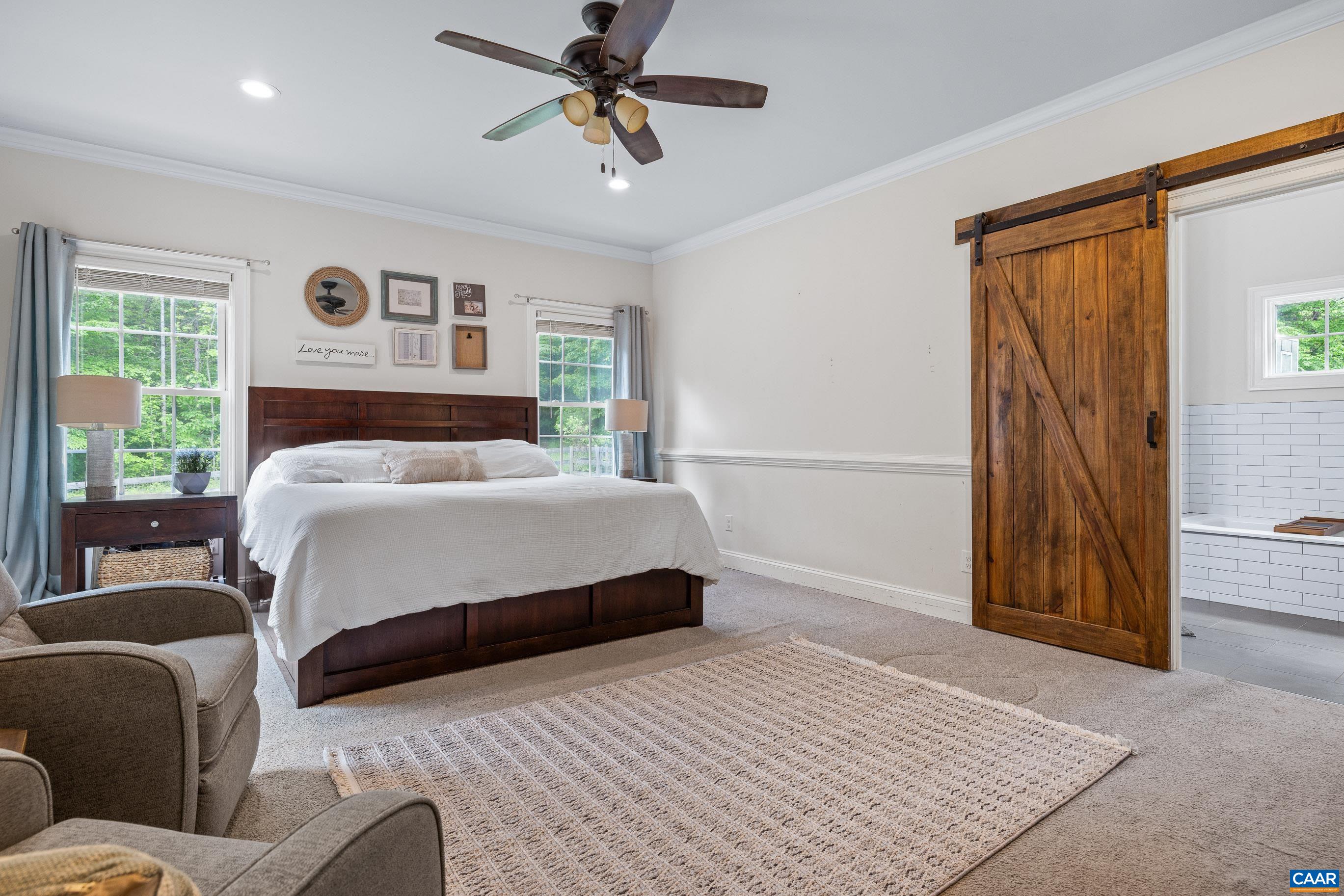 7325 3 Notch Road Louisa, VA 23093 - Photo 28 of 65 a bedroom with a bed and a chandelier