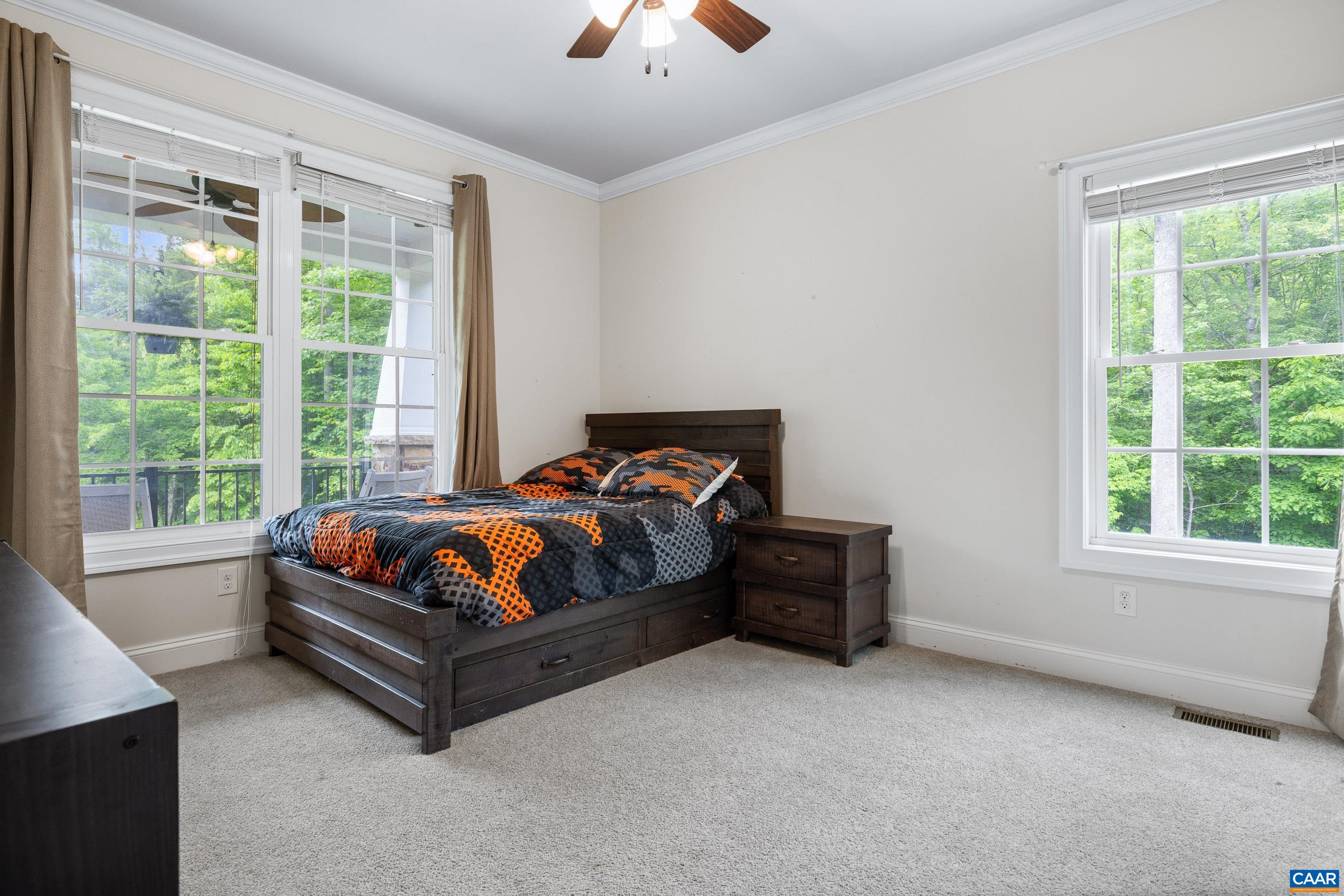 7325 3 Notch Road Louisa, VA 23093 - Photo 37 of 65 a spacious bedroom with a bed and a couch