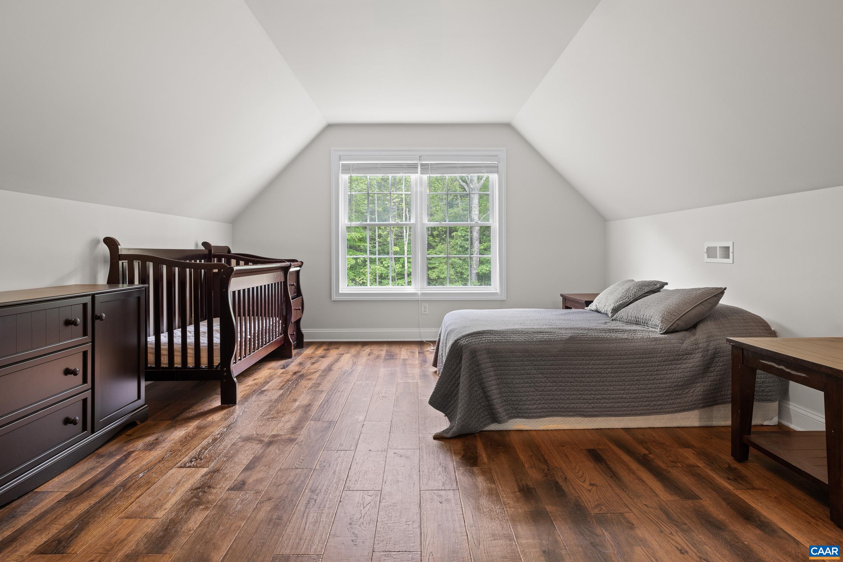 7325 3 Notch Road Louisa, VA 23093 - Photo 47 of 65 a spacious bedroom with a bed a dresser and a large window