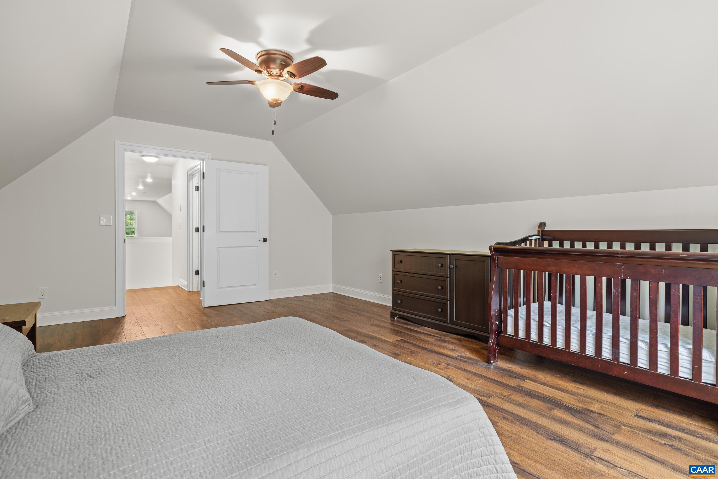 7325 3 Notch Road Louisa, VA 23093 - Photo 48 of 65 a bedroom with a bed and a chandelier