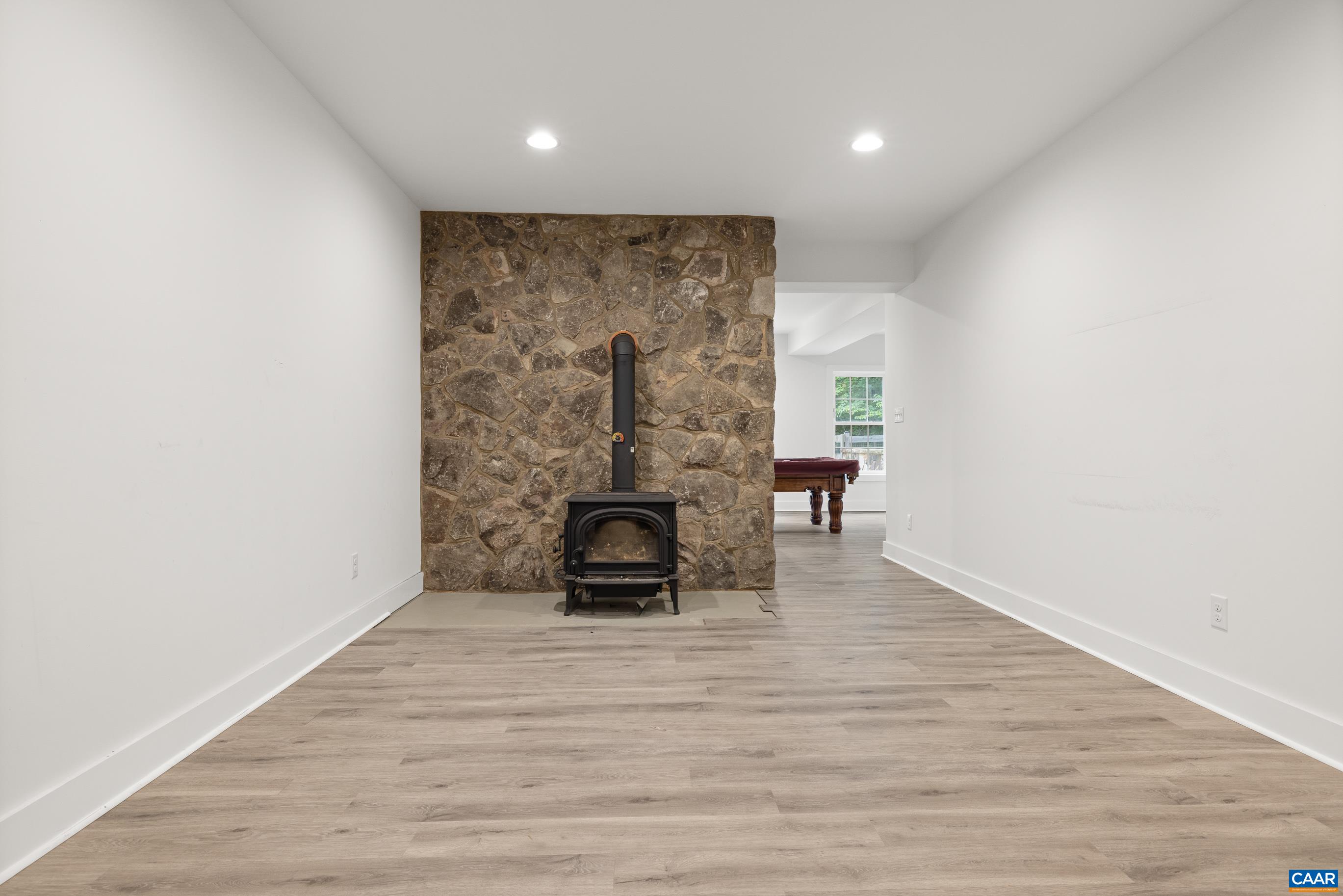 7325 3 Notch Road Louisa, VA 23093 - Photo 57 of 65 a view of empty room with a fireplace and wooden floor