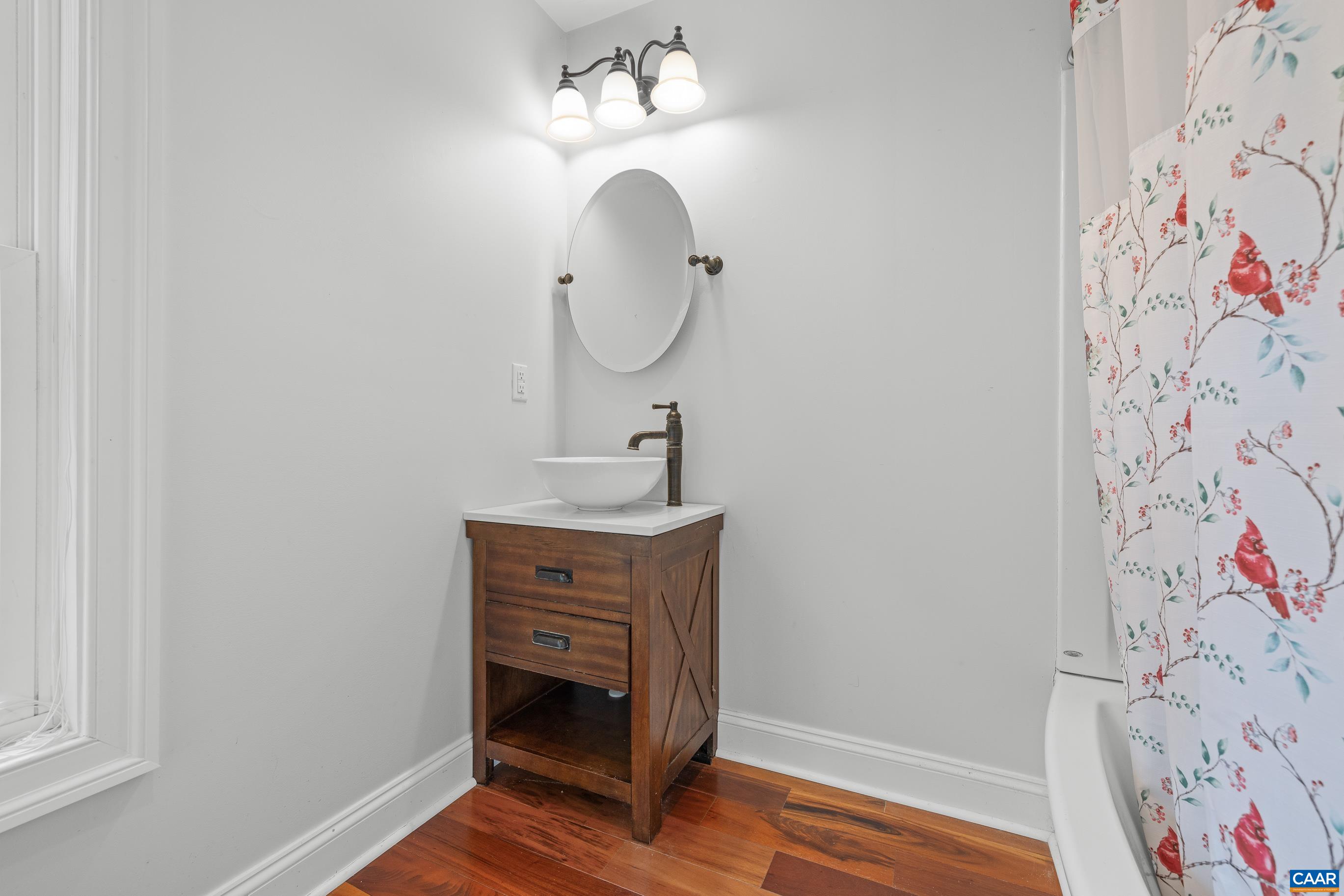7325 3 Notch Road Louisa, VA 23093 - Photo 65 of 65 a bathroom with a sink and a mirror