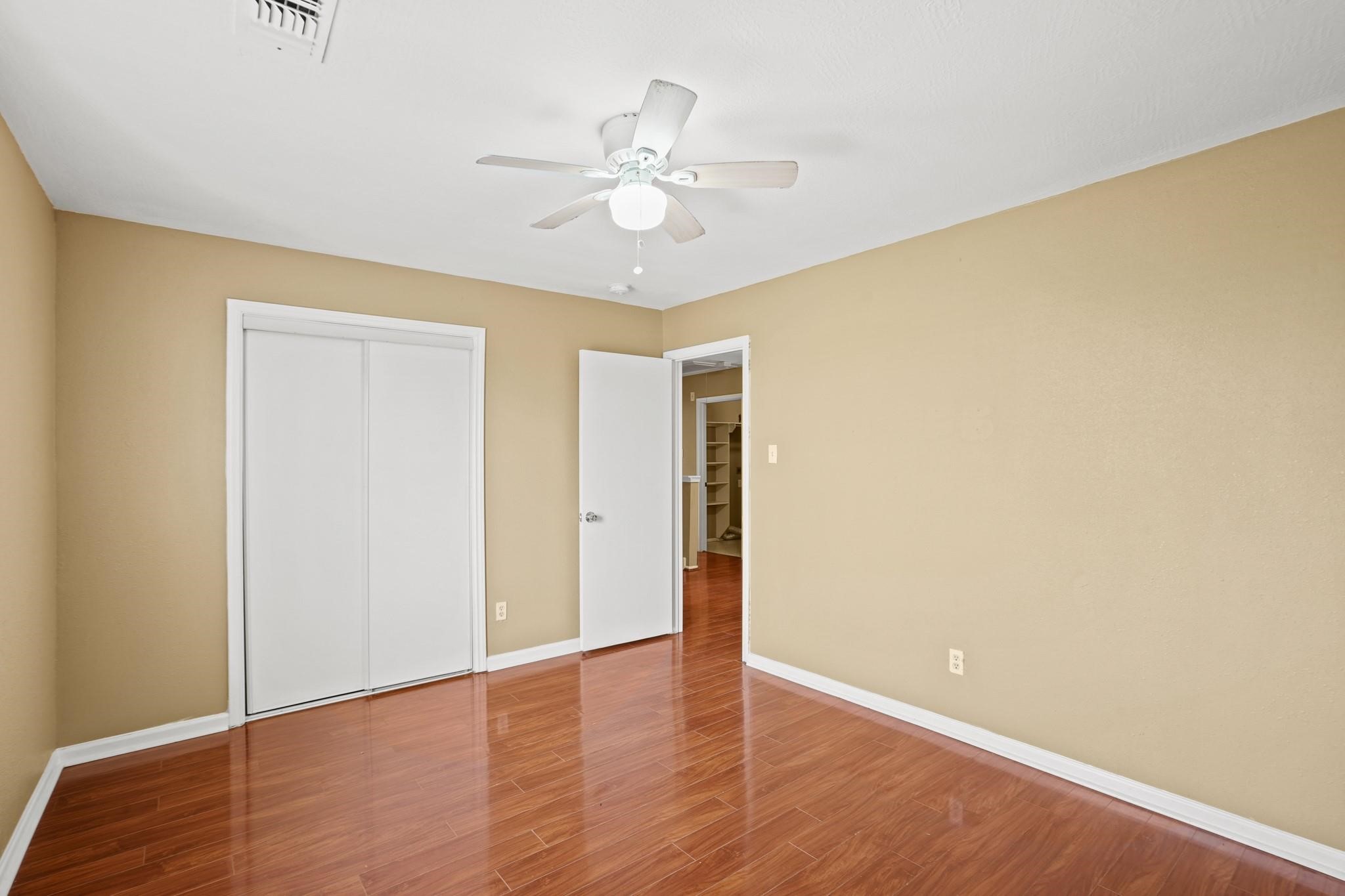 5003 East Parma Drive Rosenberg, TX 77471 - Photo 16 of 25 a view of an empty room with wooden floor