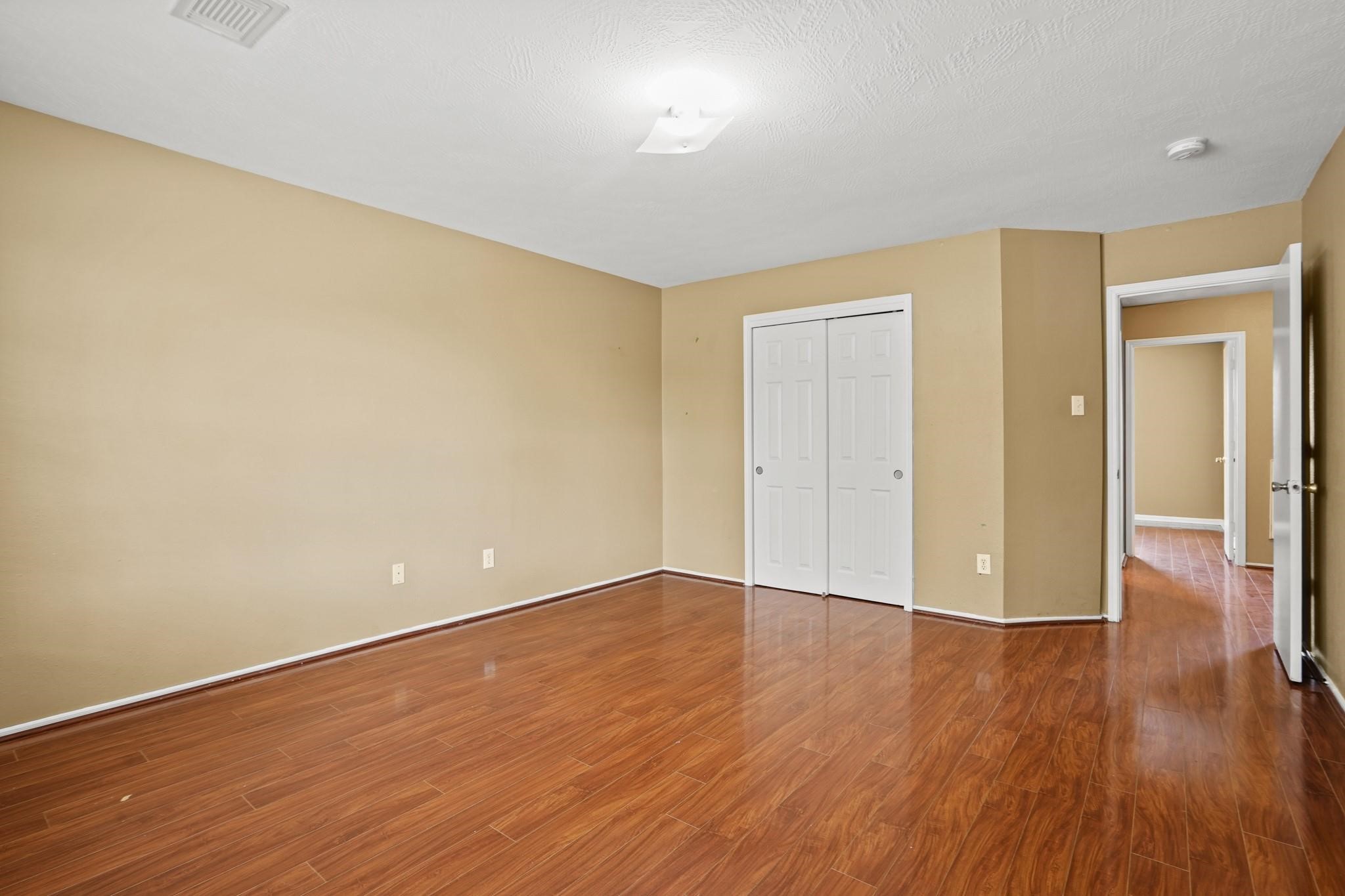 5003 East Parma Drive Rosenberg, TX 77471 - Photo 19 of 25 a view of an empty room with wooden floor
