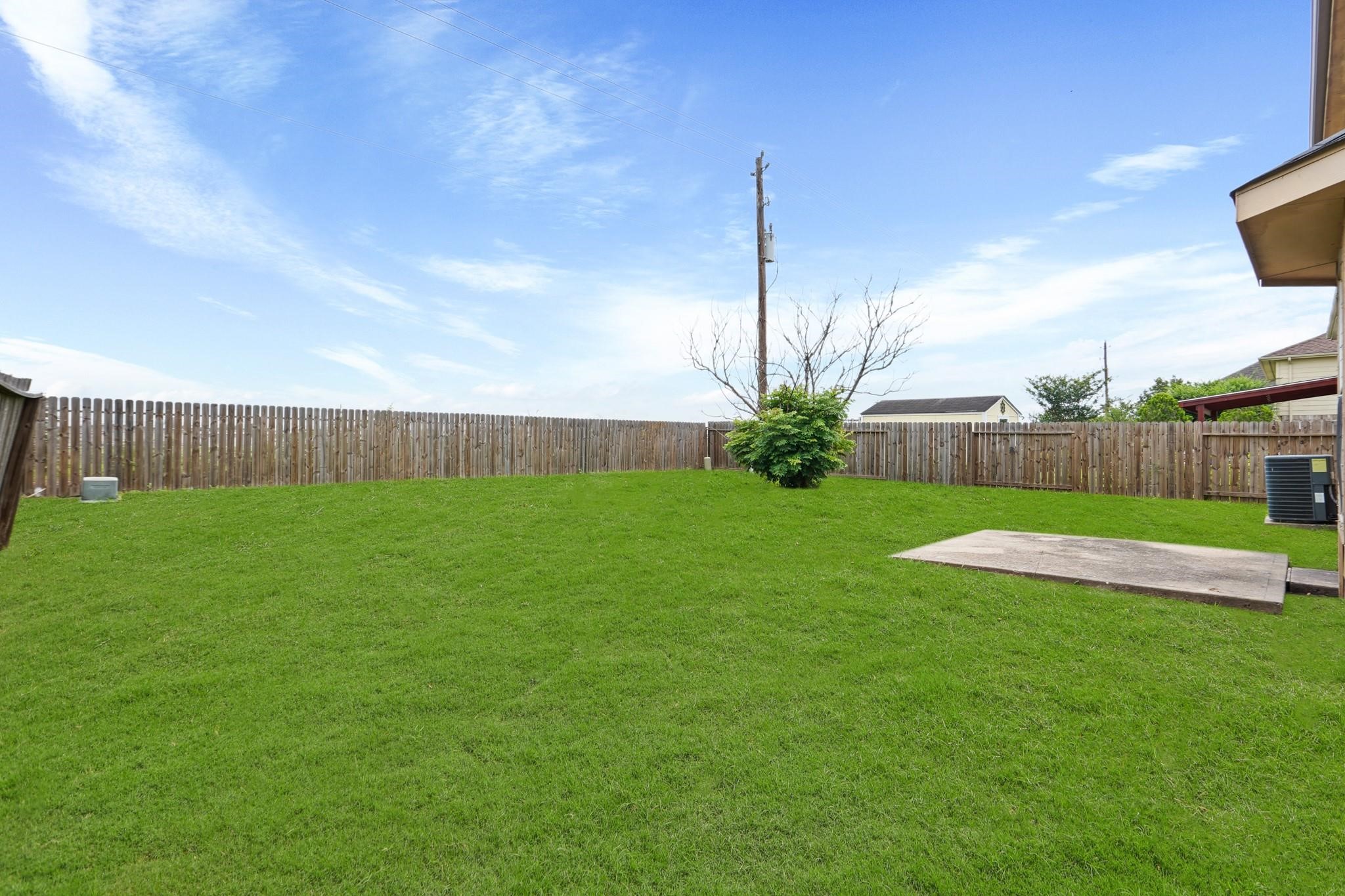 5003 East Parma Drive Rosenberg, TX 77471 - Photo 24 of 25 a view of a garden with a large tree