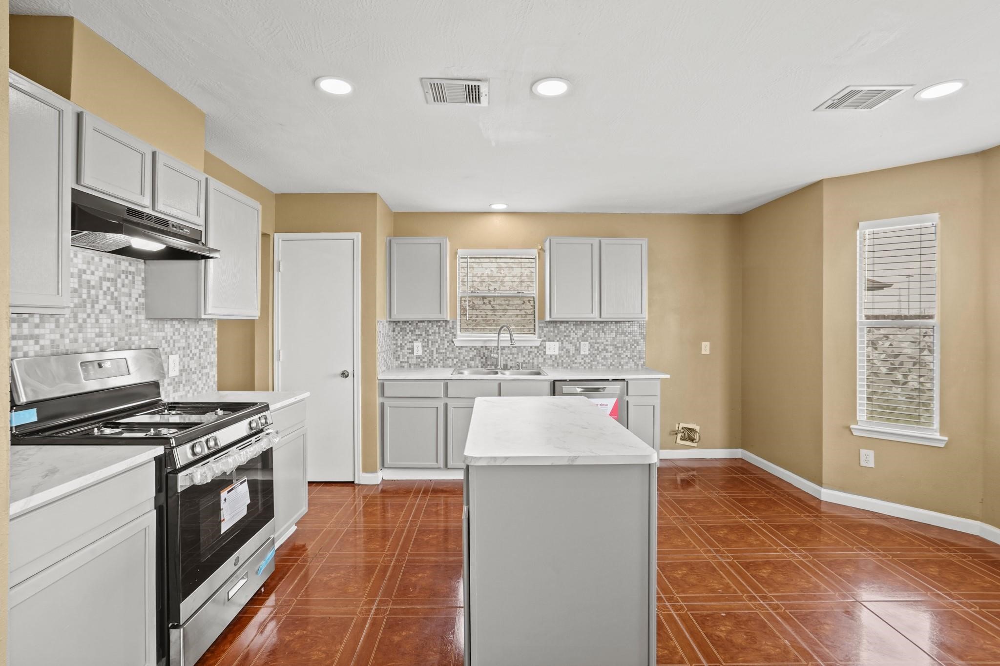 5003 East Parma Drive Rosenberg, TX 77471 - Photo 6 of 25 a kitchen with a refrigerator and a stove top oven