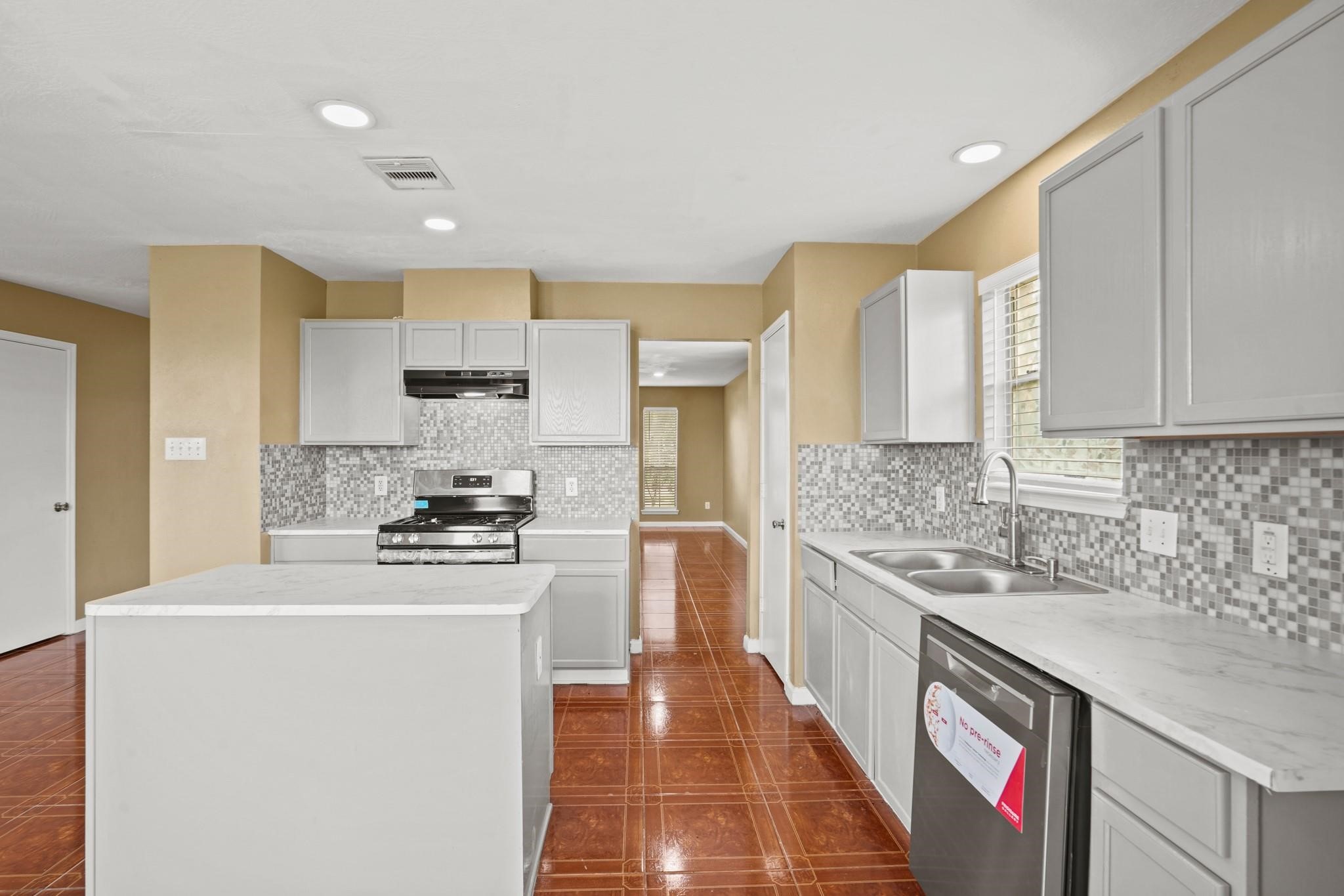 5003 East Parma Drive Rosenberg, TX 77471 - Photo 7 of 25 a kitchen with stainless steel appliances granite countertop a sink stove and refrigerator