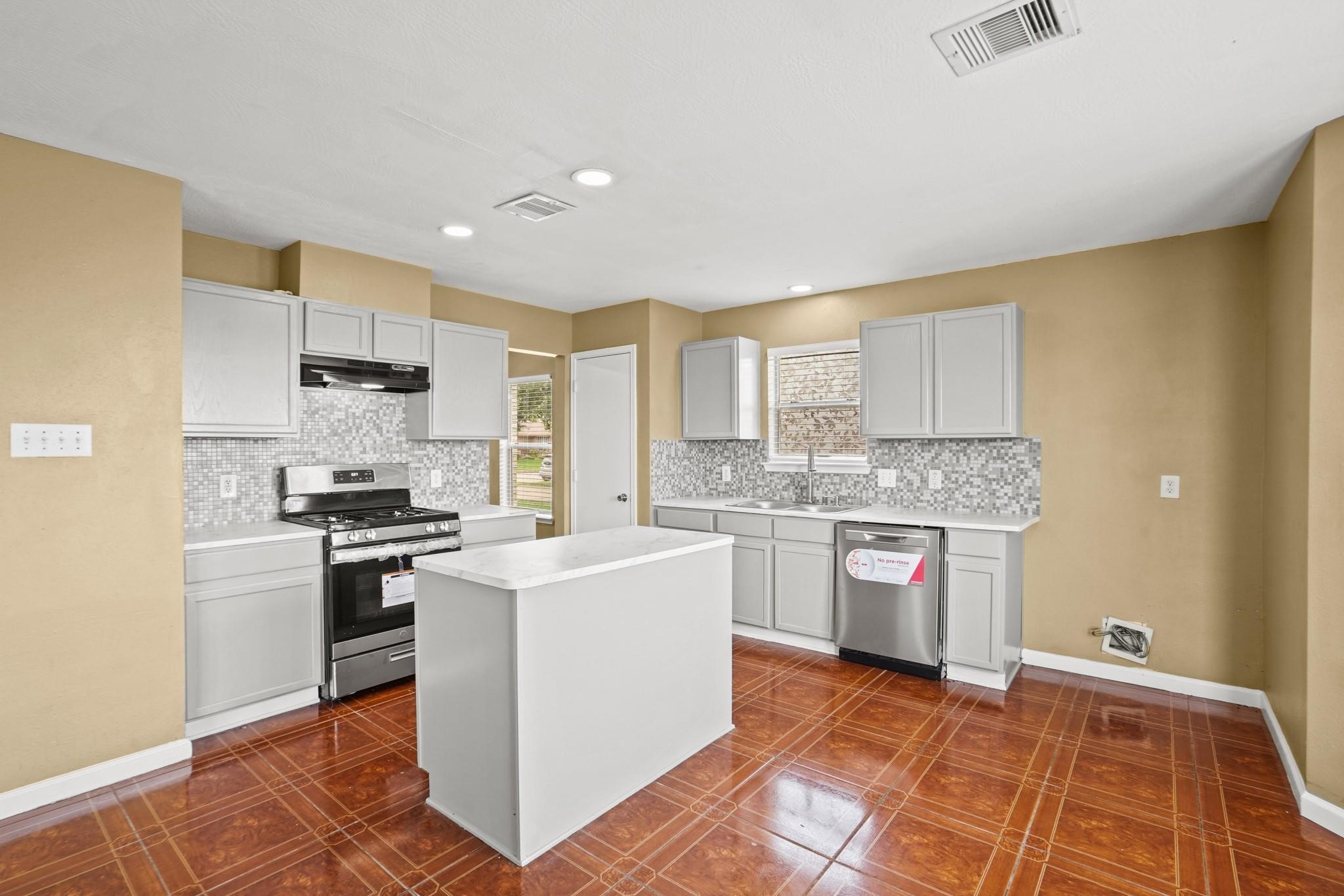 5003 East Parma Drive Rosenberg, TX 77471 - Photo 8 of 25 a kitchen with a stove top oven sink and cabinets