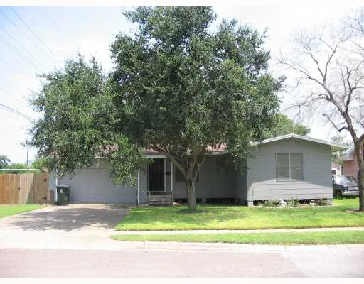 a house that has a tree in front of it