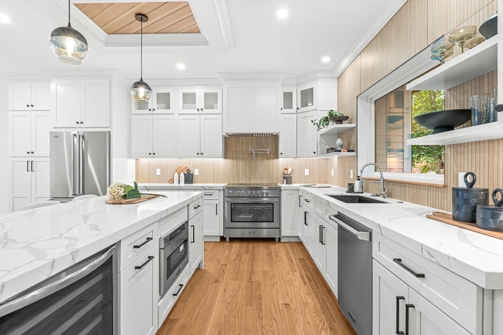443 Central Avenue Needham, MA 02494 - Photo 15 of 41 a large kitchen with stainless steel appliances granite countertop a lot of counter space and wooden floors
