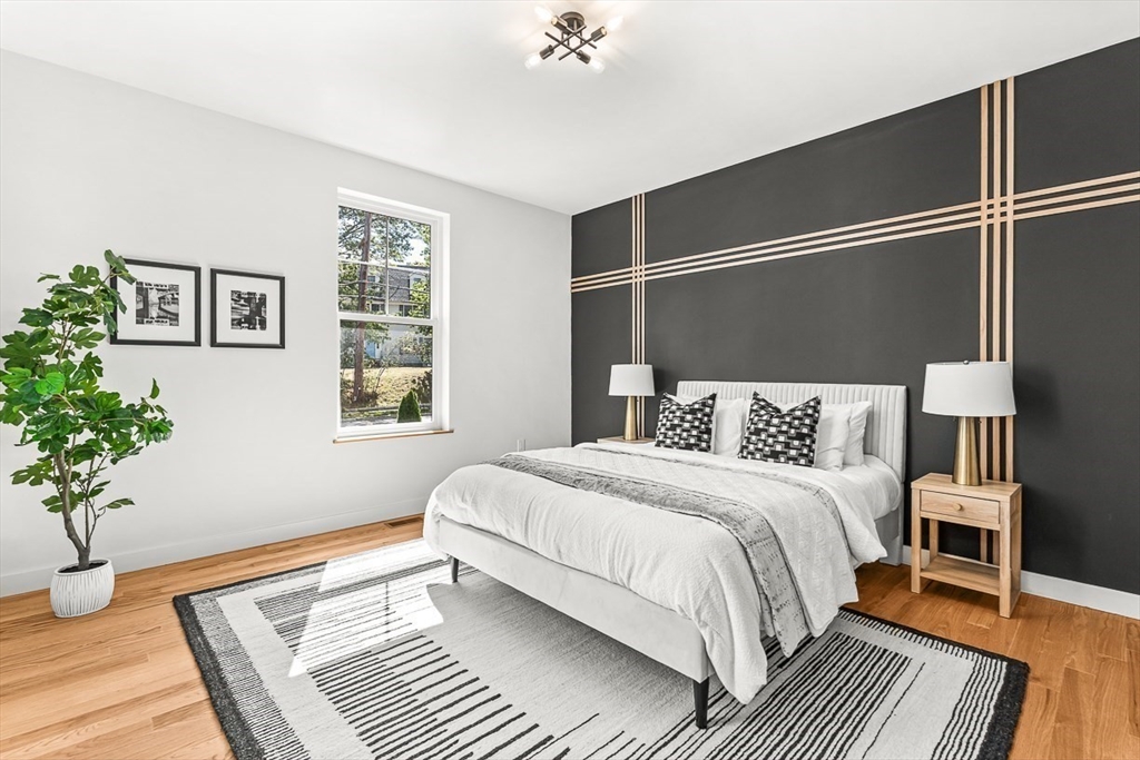 443 Central Avenue Needham, MA 02494 - Photo 19 of 41 a bedroom with a large bed and a potted plant