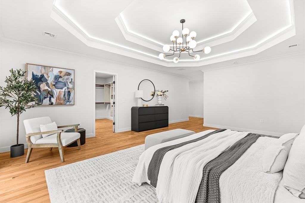 443 Central Avenue Needham, MA 02494 - Photo 24 of 41 a bedroom with a bed and a chandelier