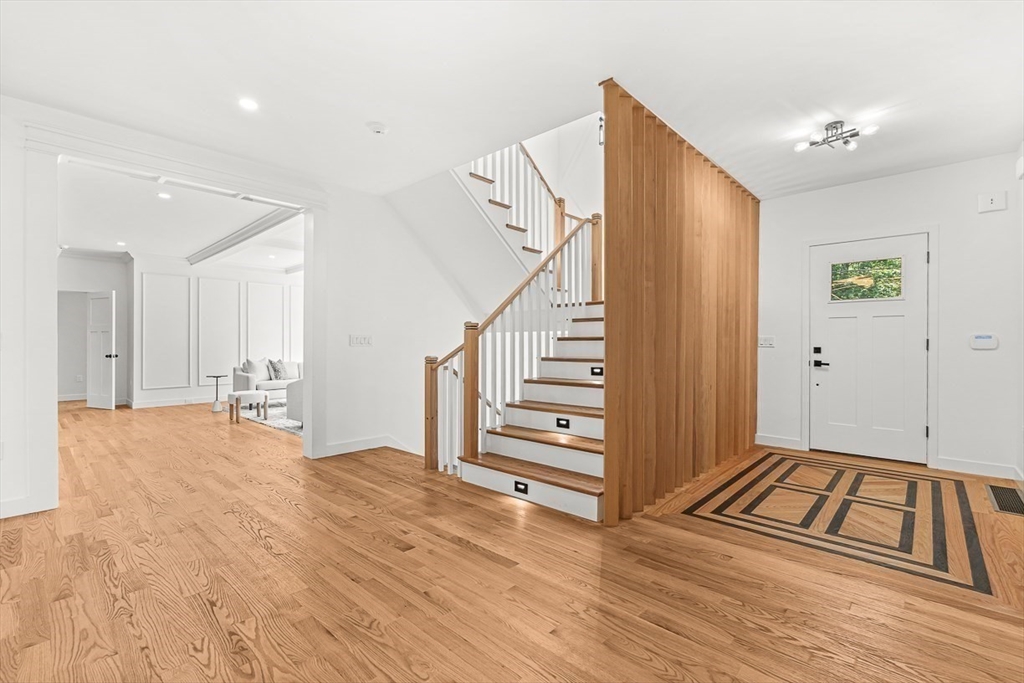 443 Central Avenue Needham, MA 02494 - Photo 4 of 41 a view of an empty room with wooden floor and stairs