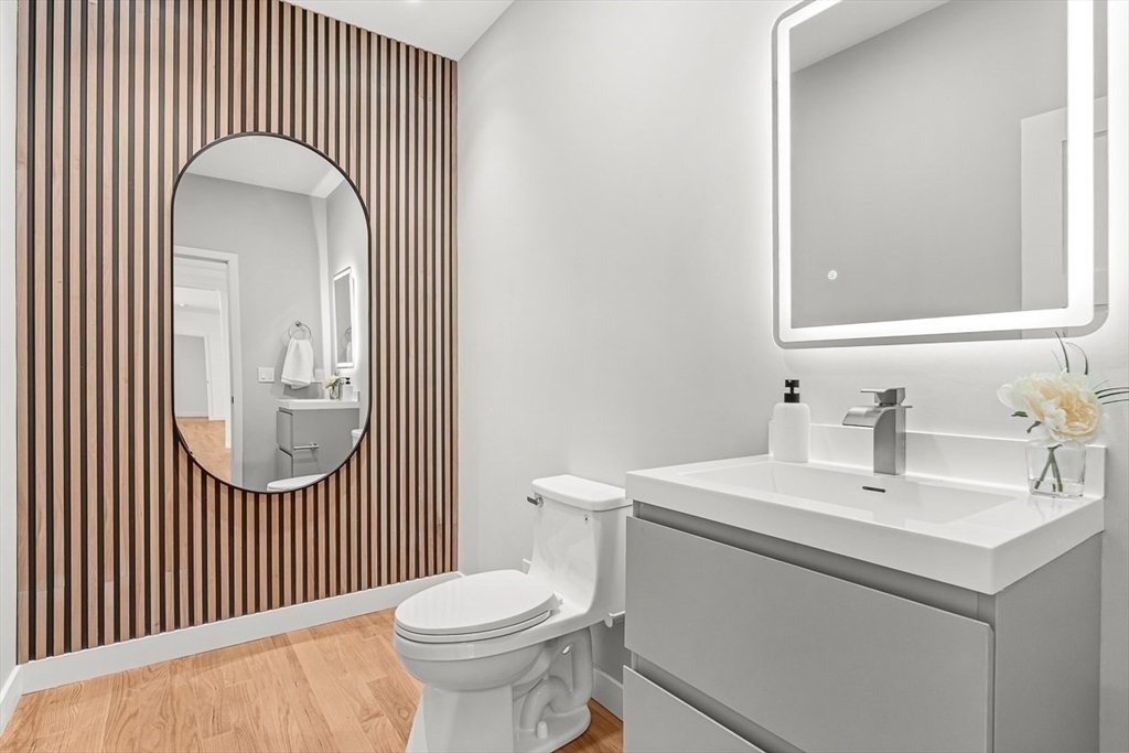 443 Central Avenue Needham, MA 02494 - Photo 6 of 41 a bathroom with a sink a toilet and a mirror