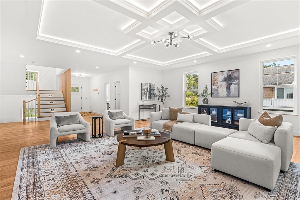 443 Central Avenue Needham, MA 02494 - Photo 9 of 41 a living room with furniture a fireplace and a chandelier