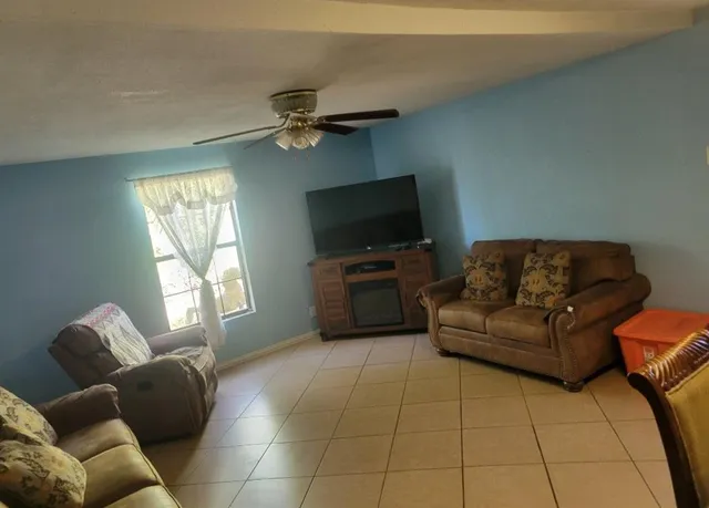 a living room with furniture and a flat screen tv