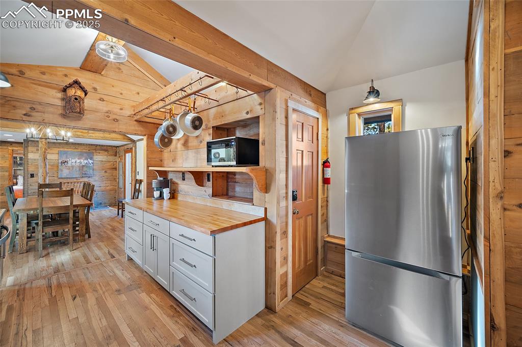 11855 Grandin Point Elbert, CO 80106 - Photo 14 of 42 a kitchen with stainless steel appliances granite countertop a refrigerator a stove a sink and a dining table with wooden floor