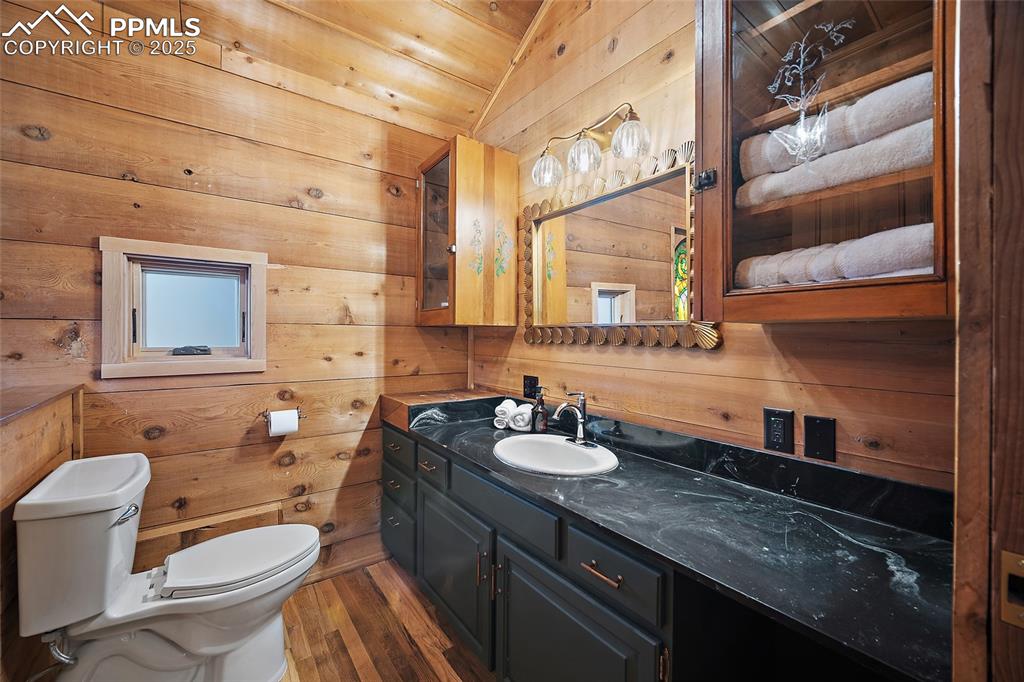 11855 Grandin Point Elbert, CO 80106 - Photo 18 of 42 a bathroom with a granite countertop sink a toilet and a mirror