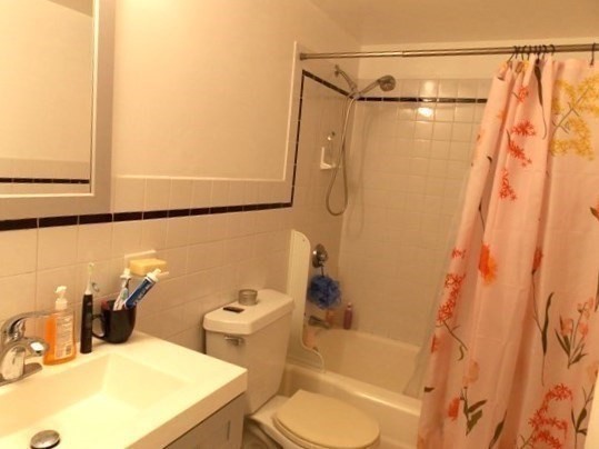 514 Harvard Street, Unit 2D Brookline, MA 02446 - Photo 6 of 11 a bathroom with a sink toilet and shower
