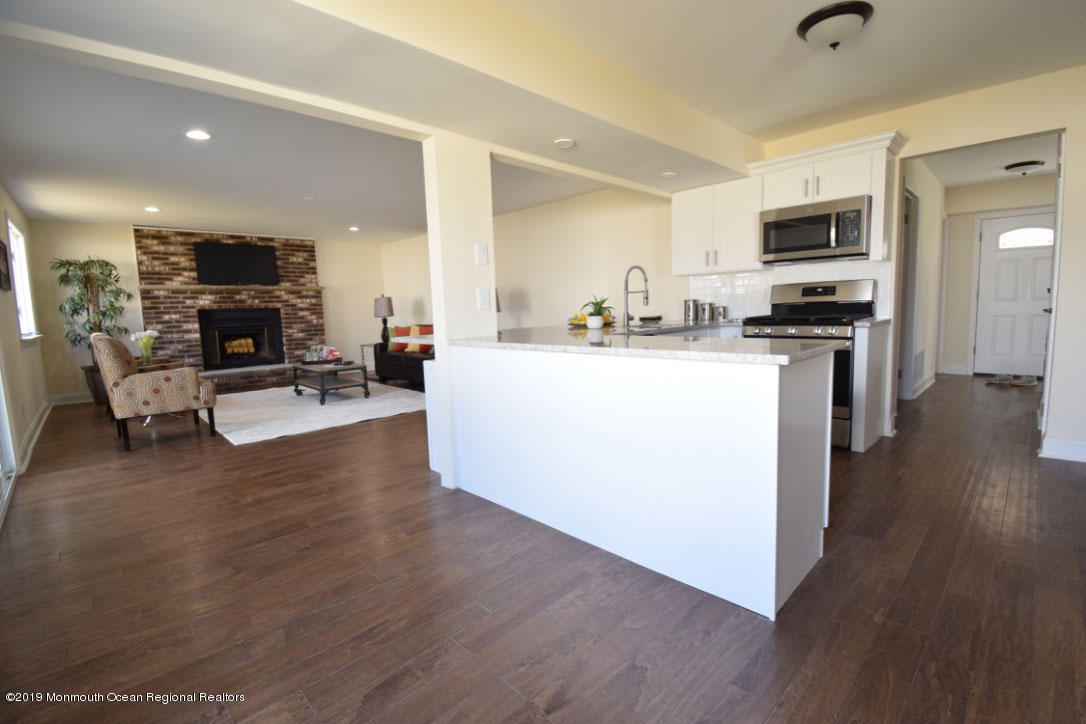 66 Starlight Road Howell, NJ 07731 - Photo 3 of 27 a living room with stainless steel appliances furniture and a wooden floor