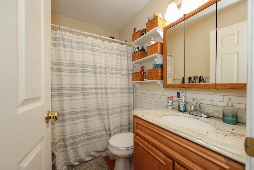 1450 Main Street Athol, MA 01331 - Photo 12 of 42 a bathroom with a sink a toilet and shower curtain