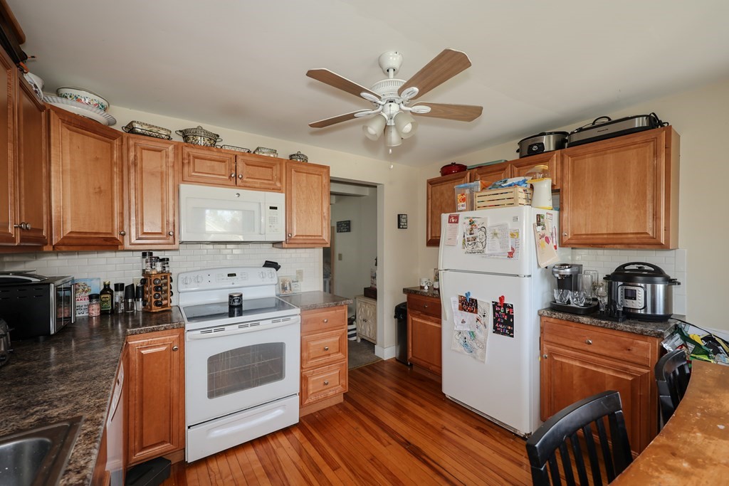 1450 Main Street Athol, MA 01331 - Photo 24 of 42 a kitchen with stainless steel appliances a stove a sink dishwasher and a refrigerator with wooden floor