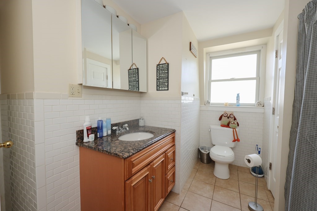 1450 Main Street Athol, MA 01331 - Photo 27 of 42 a bathroom with a granite countertop sink a toilet and a mirror