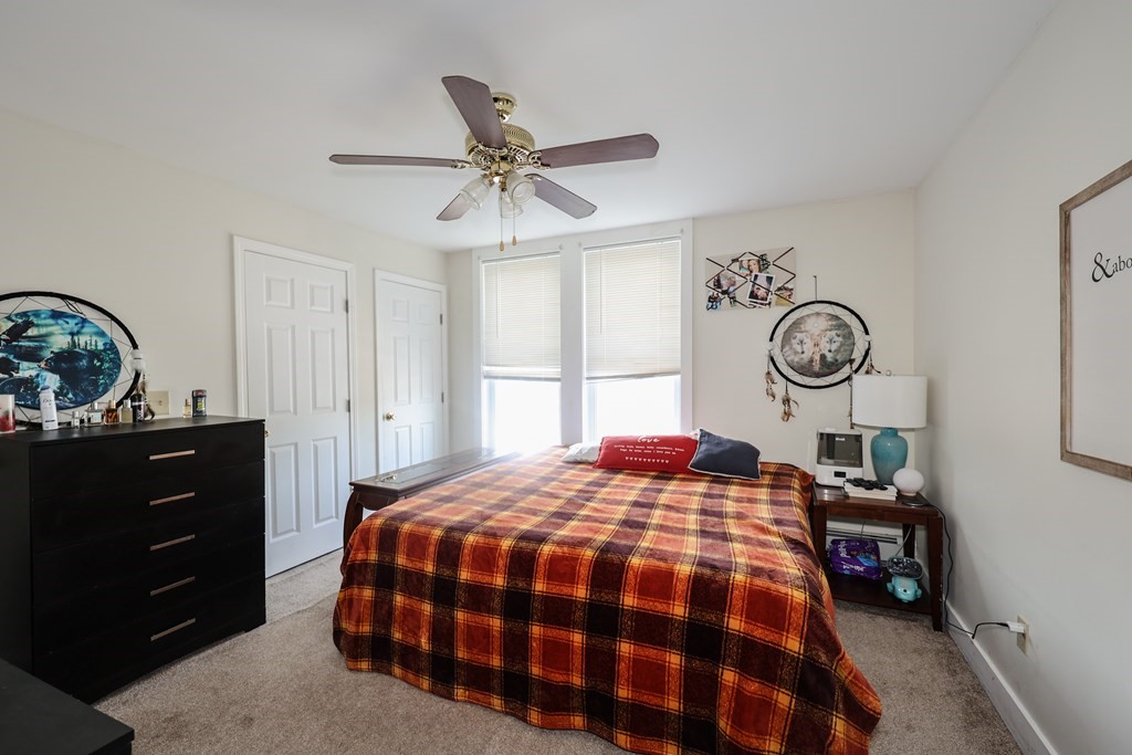 1450 Main Street Athol, MA 01331 - Photo 28 of 42 a bedroom with a bed a clock and a window