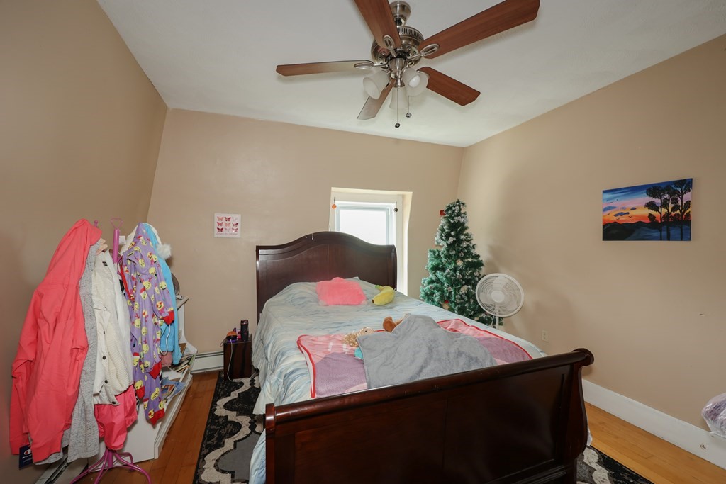 1450 Main Street Athol, MA 01331 - Photo 39 of 42 a bedroom with a bed and a chandelier