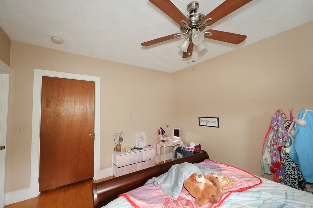 1450 Main Street Athol, MA 01331 - Photo 40 of 42 a bedroom with a bed and a dresser with wooden floor