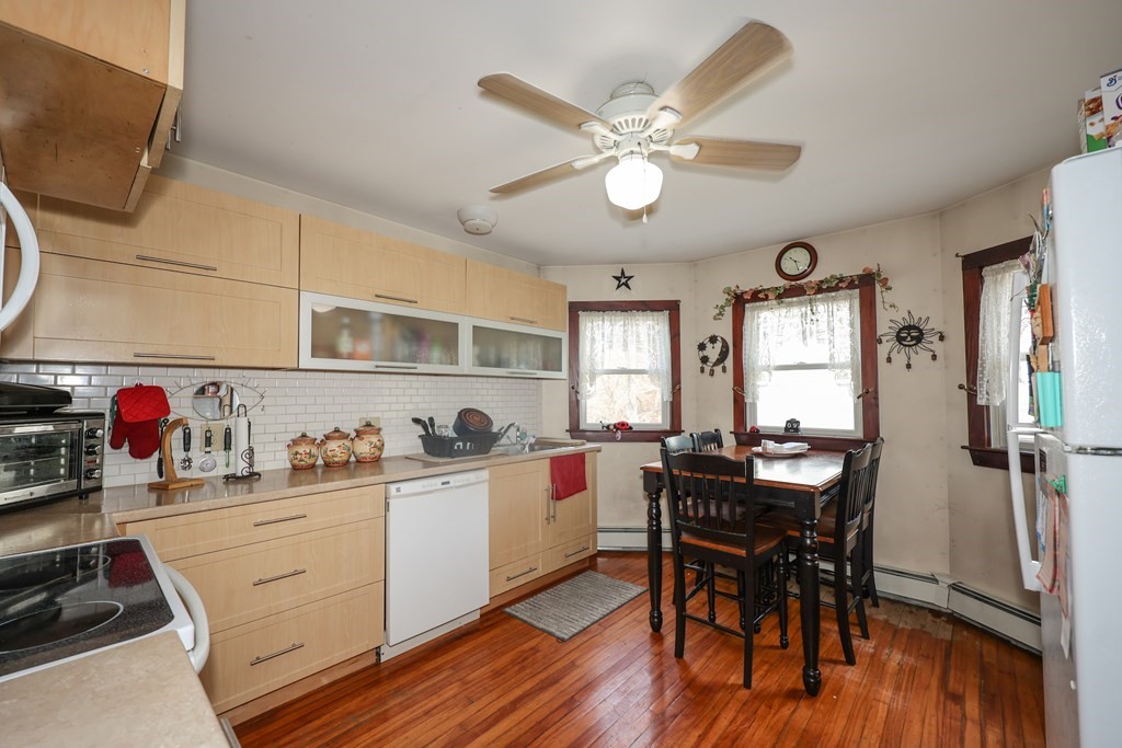 1450 Main Street Athol, MA 01331 - Photo 8 of 42 a kitchen with a dining table chairs and white cabinets